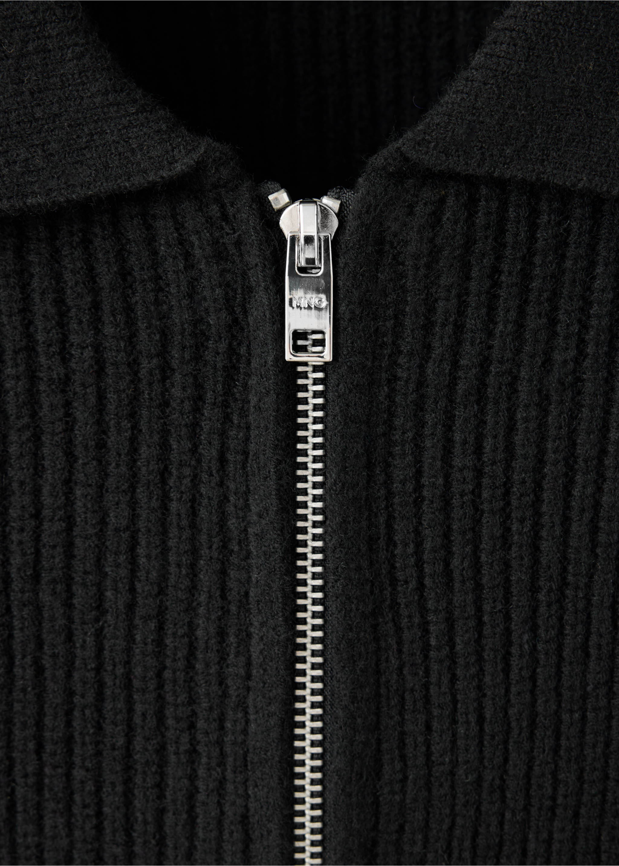 Close-up of a black ribbed cardigan with a metal zipper and collar., Black. Ref: 37067916-00.