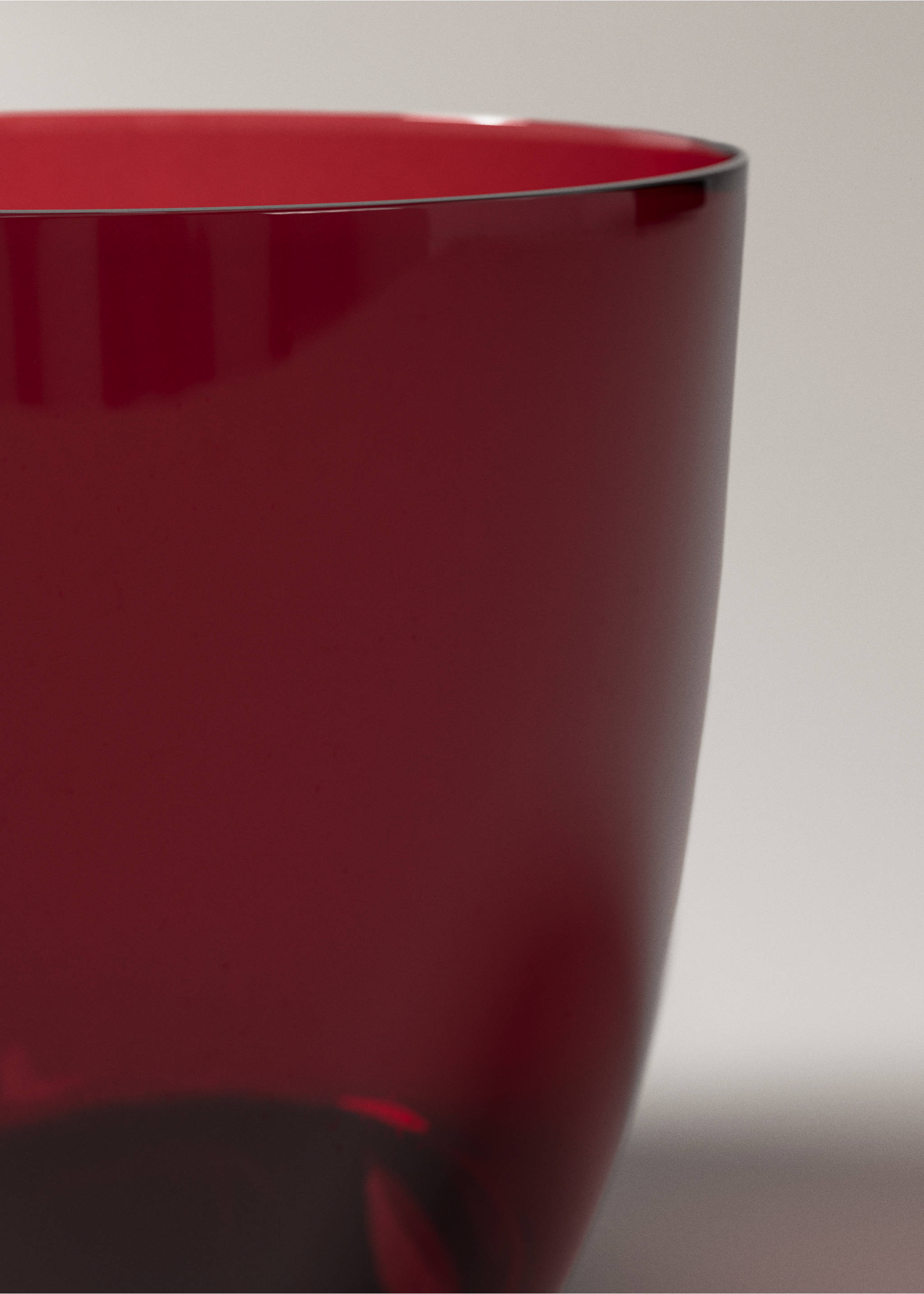 Close-up of a dark red glass tumbler rim., Red. Ref: 37067919-00.