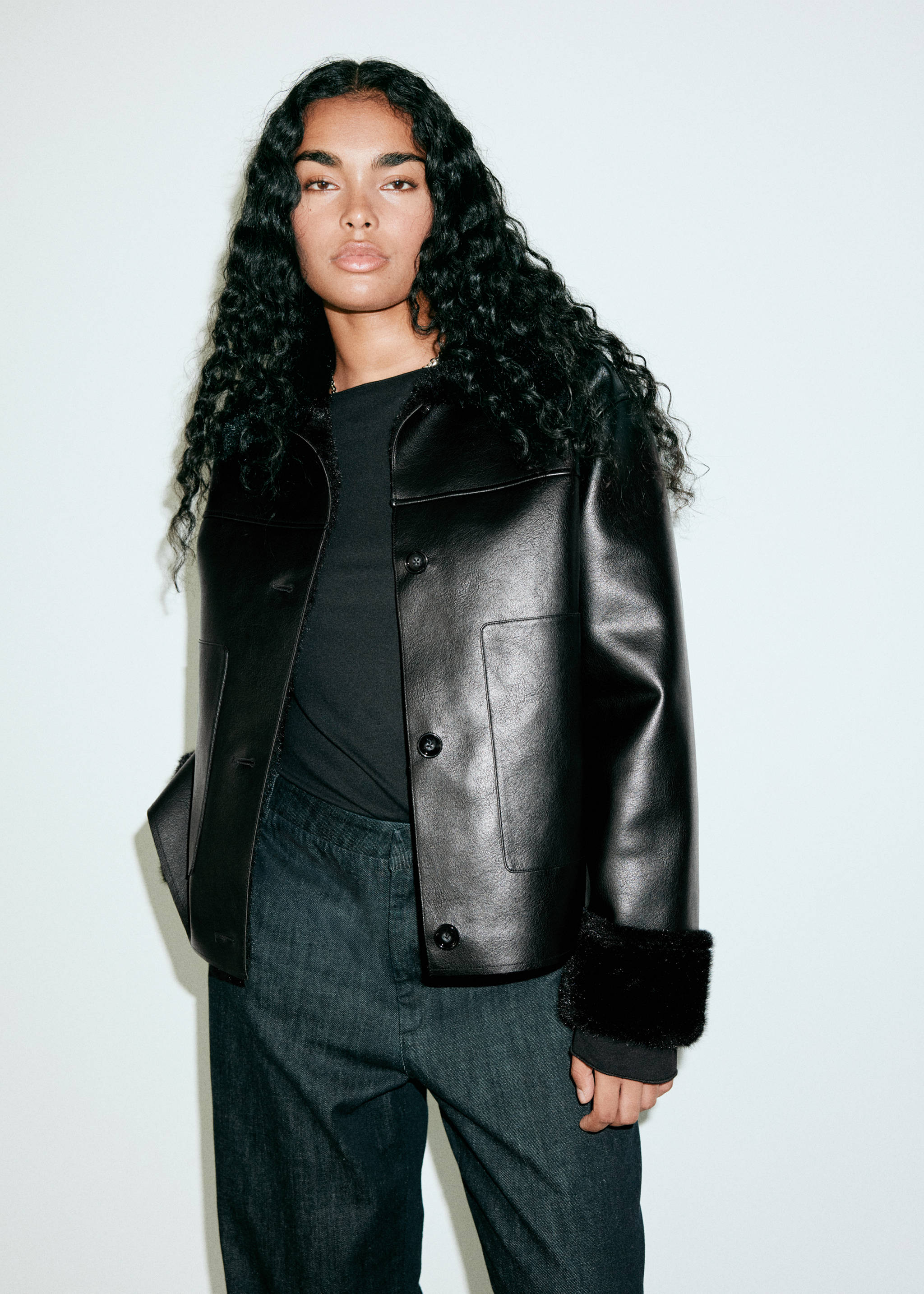 Black faux-leather jacket with faux-shearling lining and cuffs.