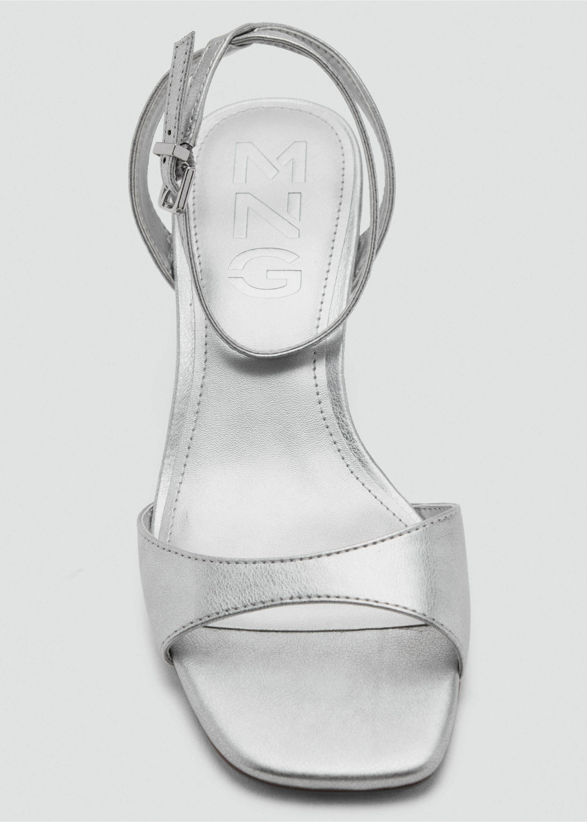 Close-up of a silver metallic sandal with a square toe and ankle strap., Silver. Ref: 37067924-00.