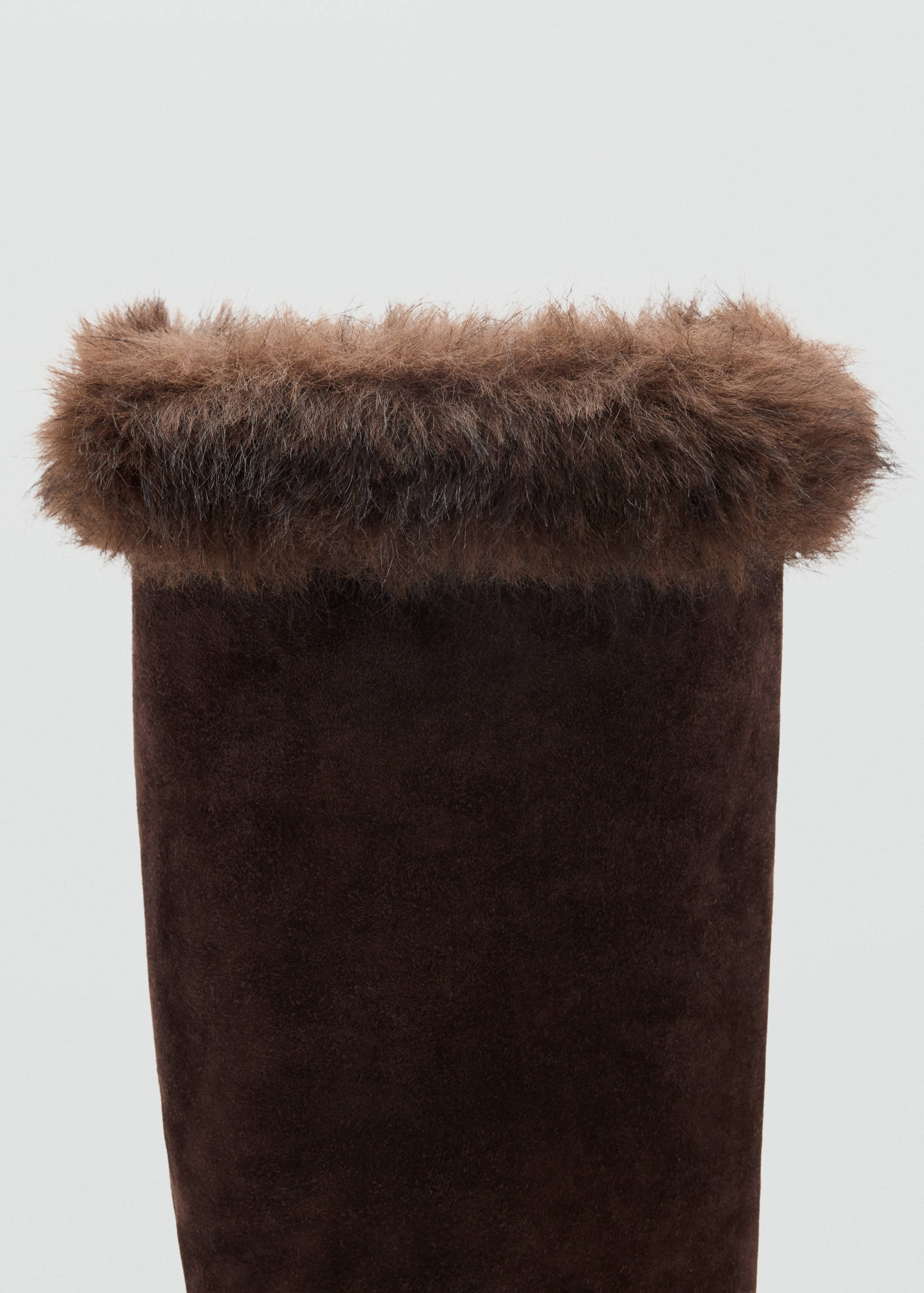 Close-up of a dark brown boot shaft with a fluffy faux-fur cuff.