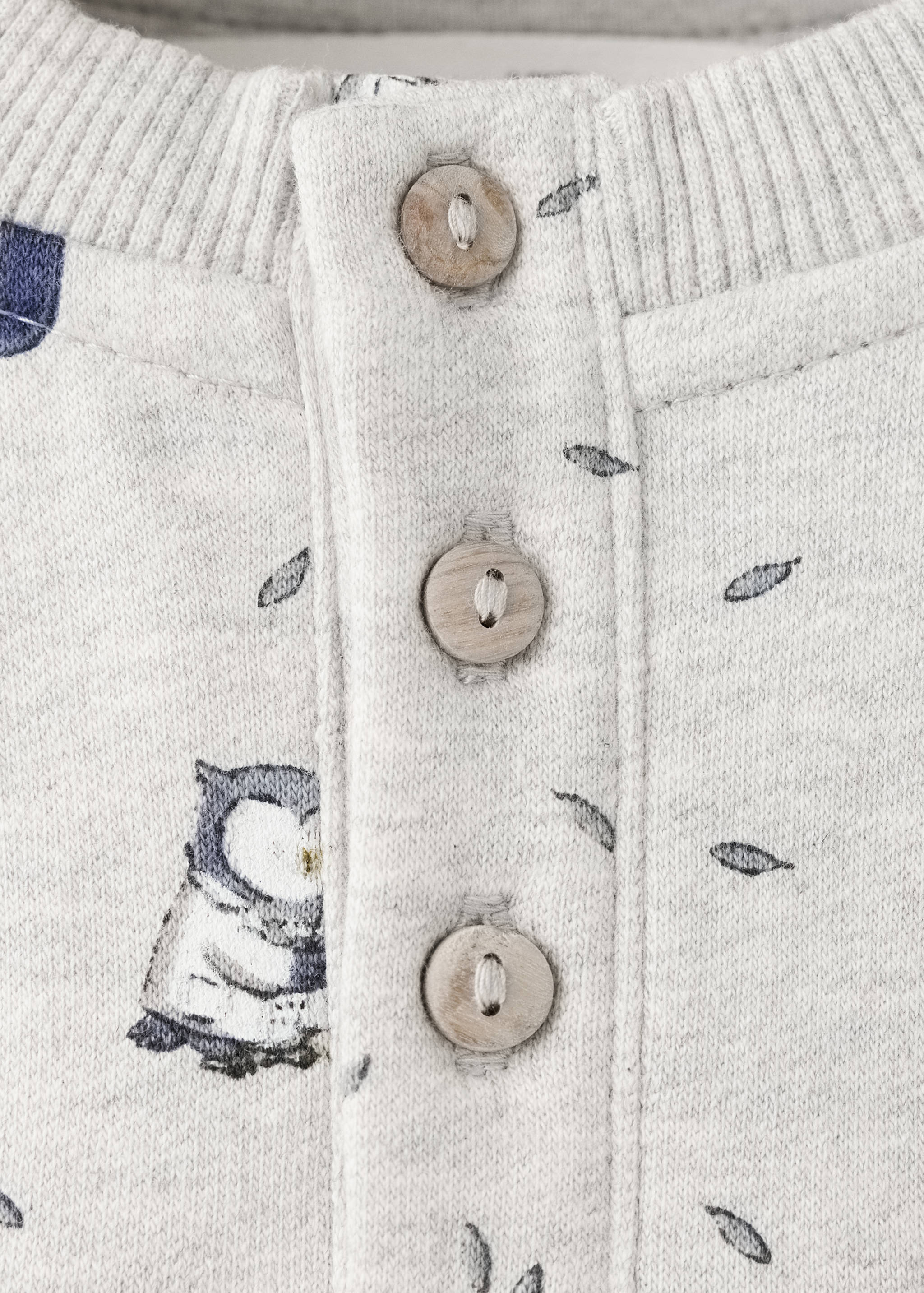 Grey children's sweatshirt neckline detail with wooden buttons