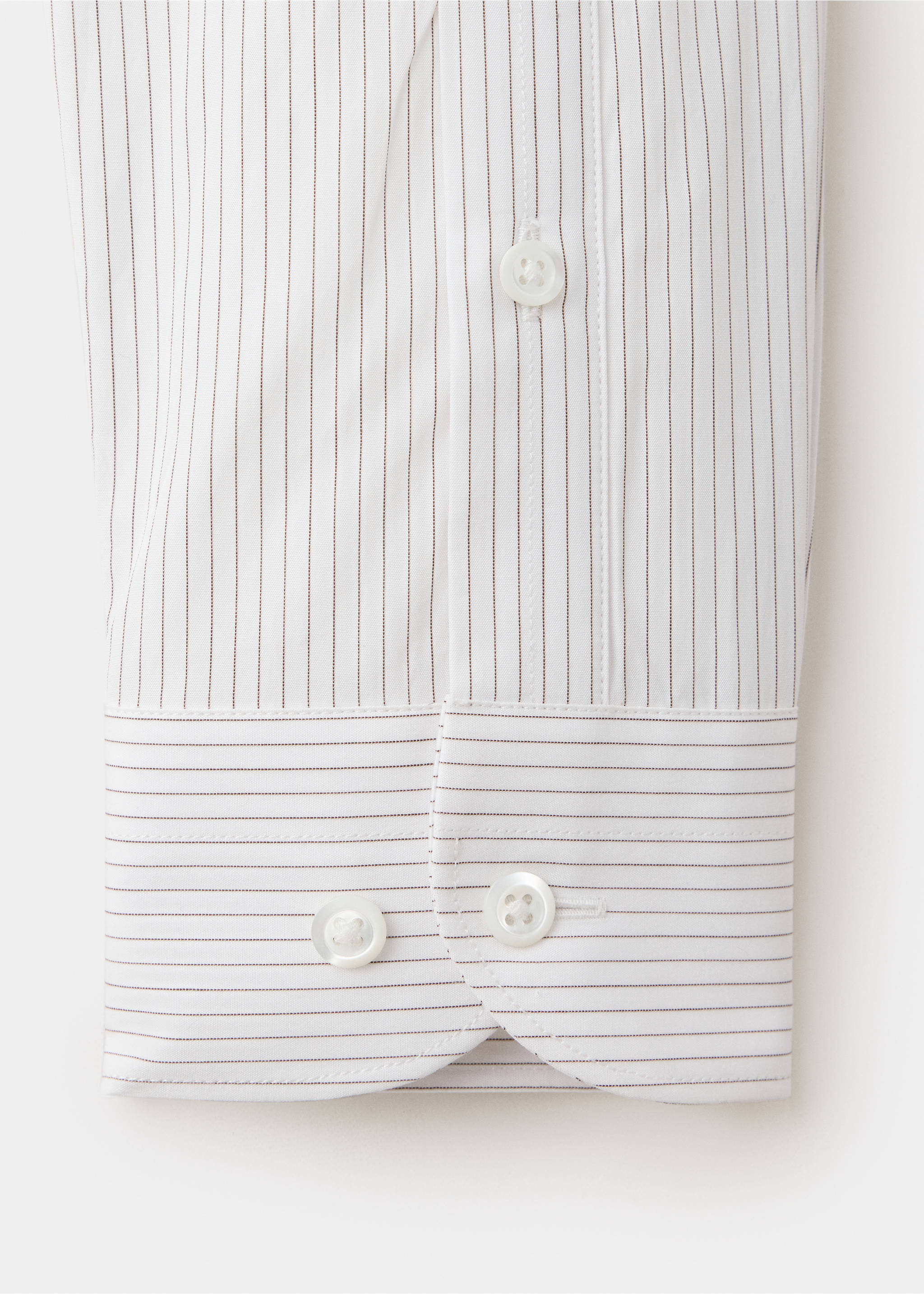 Close-up of a white shirt cuff with fine pinstripes and white buttons., White. Ref: 37067938-00.