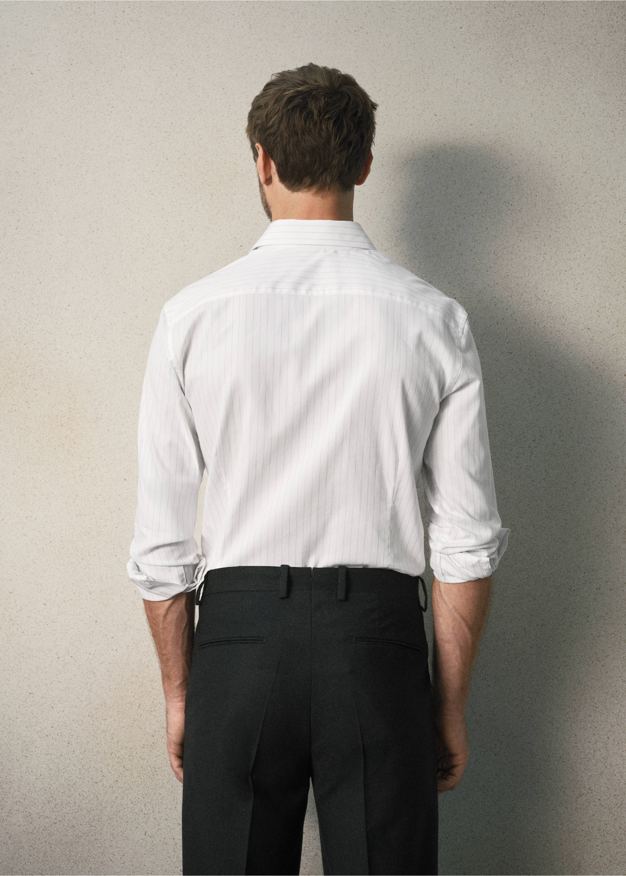 Back view of a white pinstripe shirt with long sleeves and black trousers., Grey. Ref: 37067938-00.
