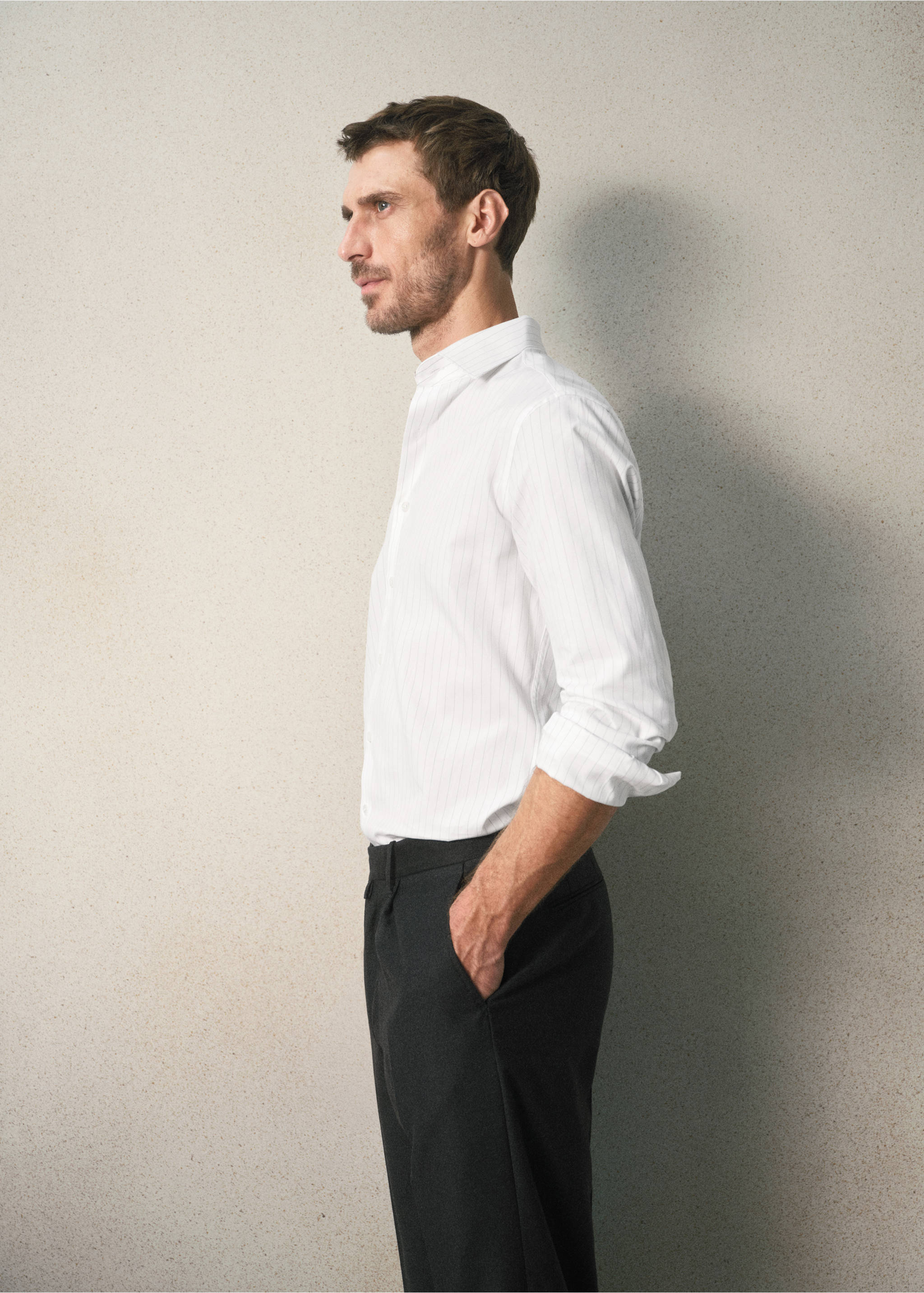 White long-sleeved shirt with a classic collar and cuffed sleeves, worn with dark trousers., Grey. Ref: 37067938-00.