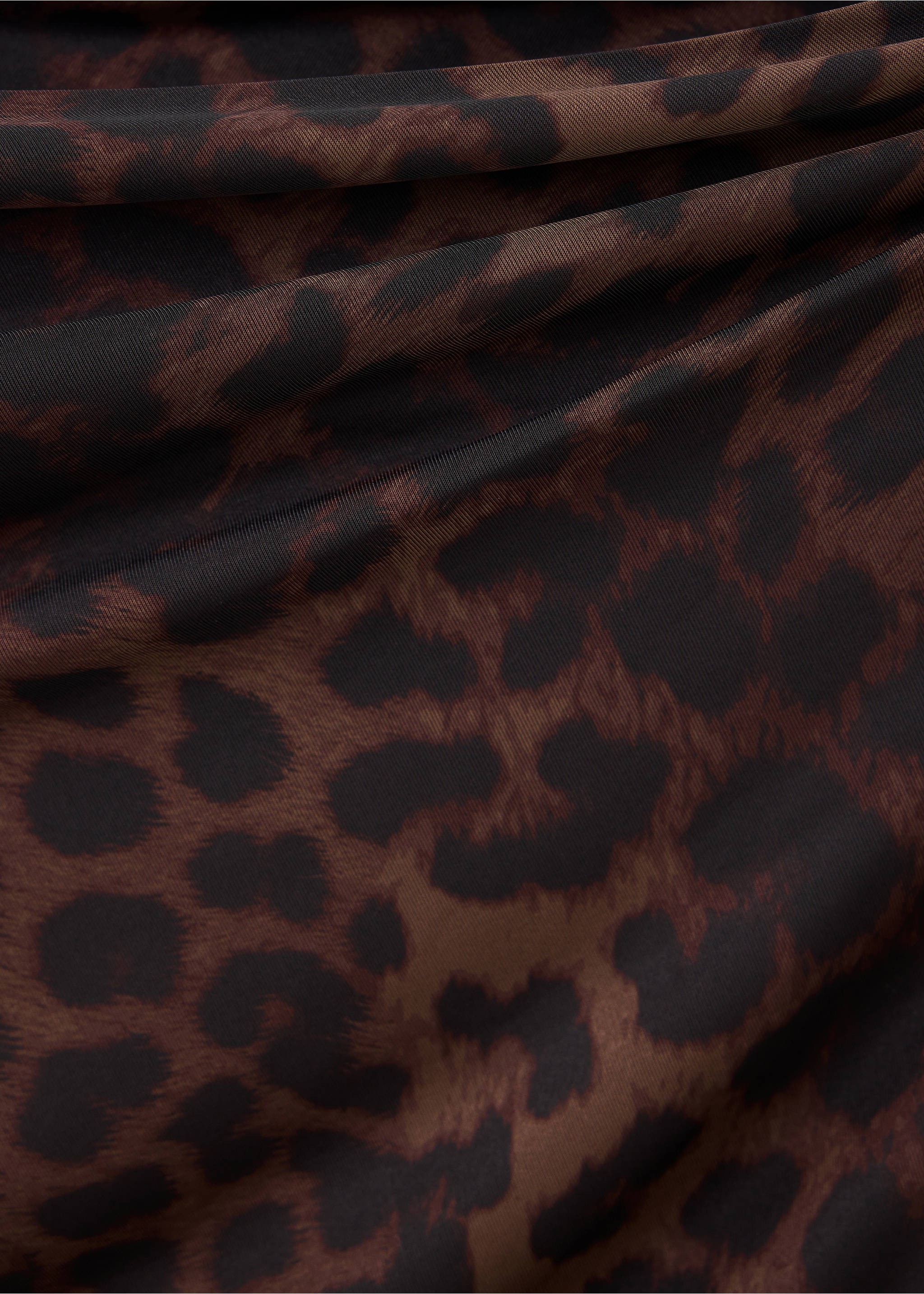 Close-up of a brown animal print dress fabric with draped folds., Brown. Ref: 37067940-00.