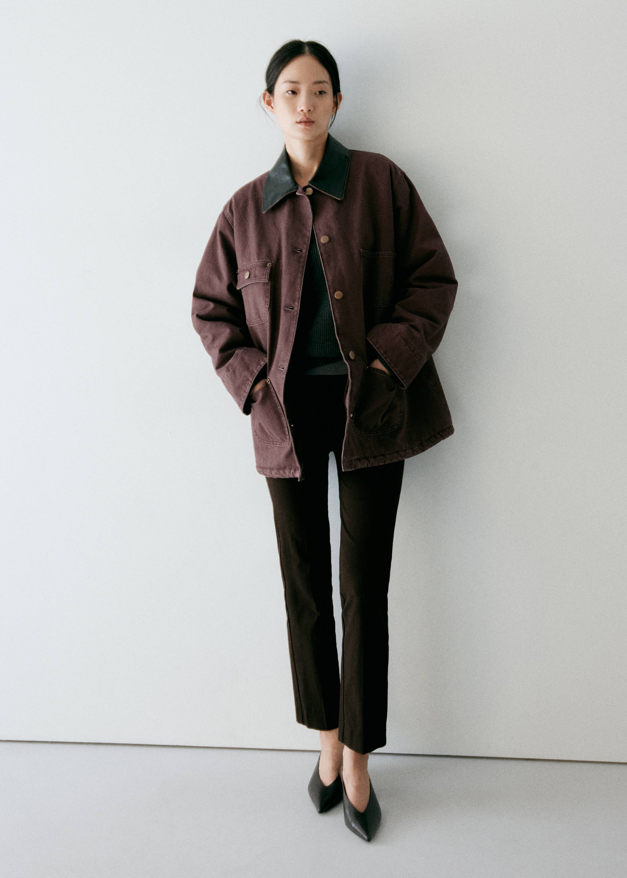 Burgundy parka with a contrasting dark collar and patch pockets.