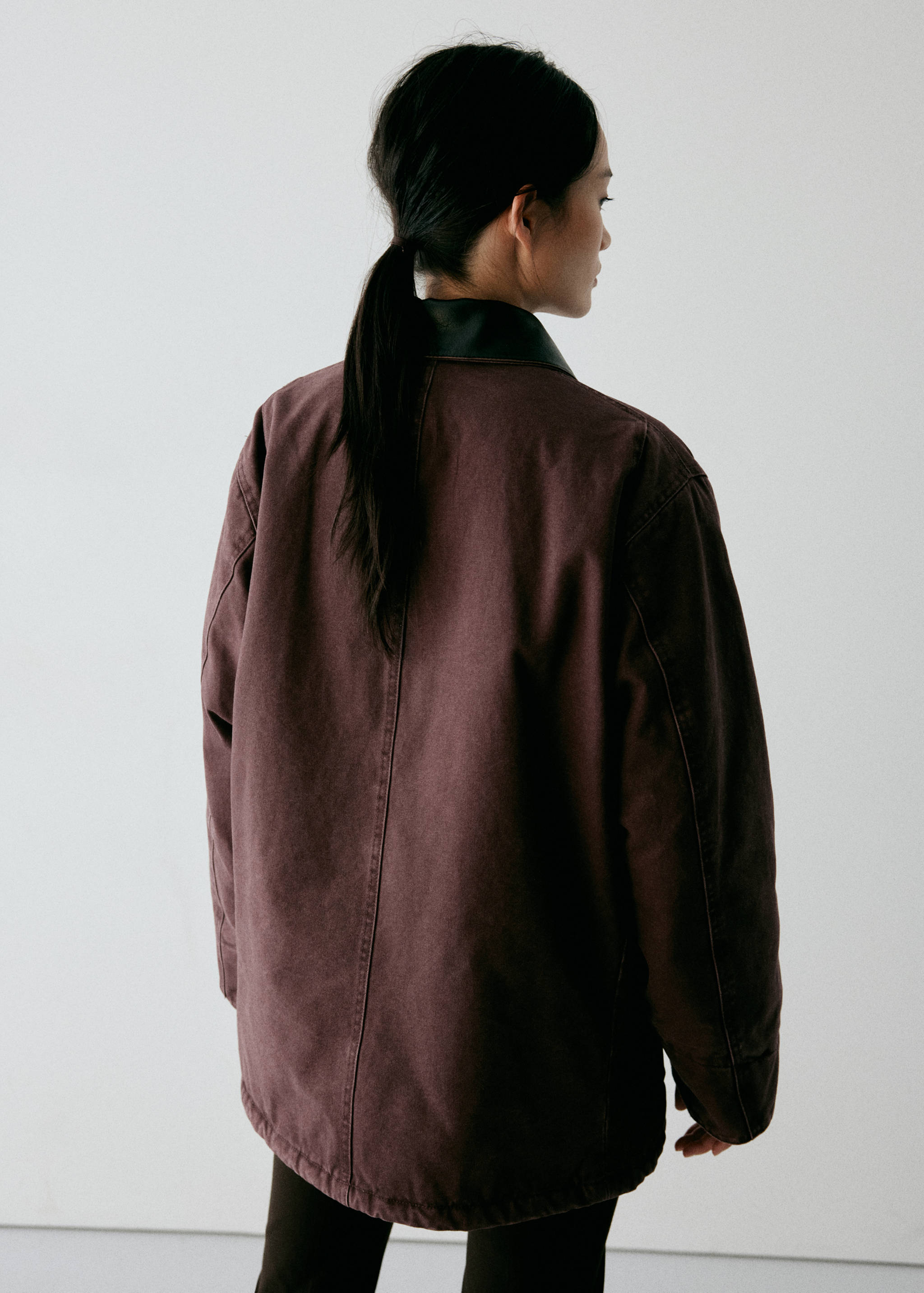 Dark burgundy oversized parka, back view.