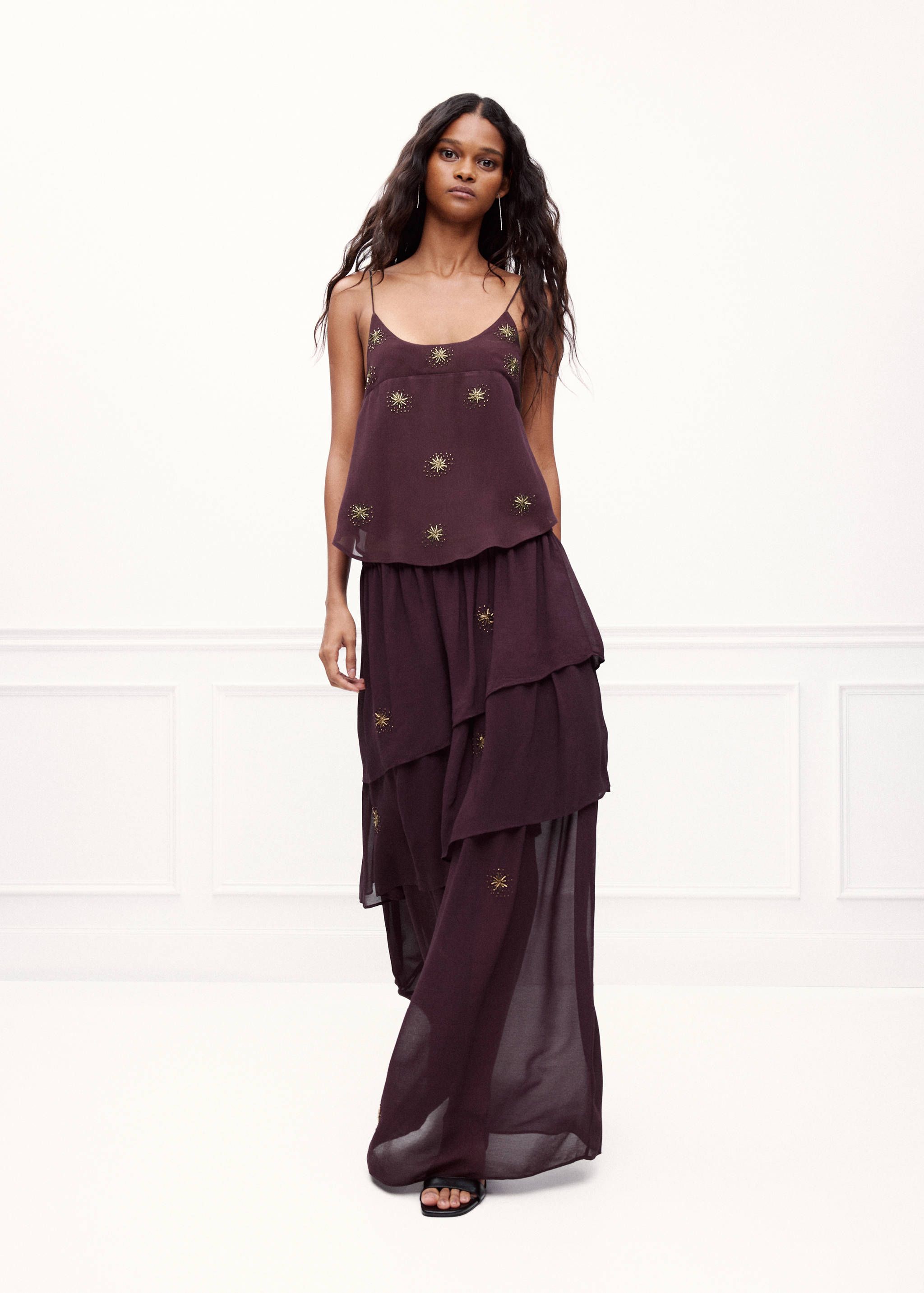 Dark plum layered maxi skirt with gold starburst embroidery, styled with a matching camisole top.