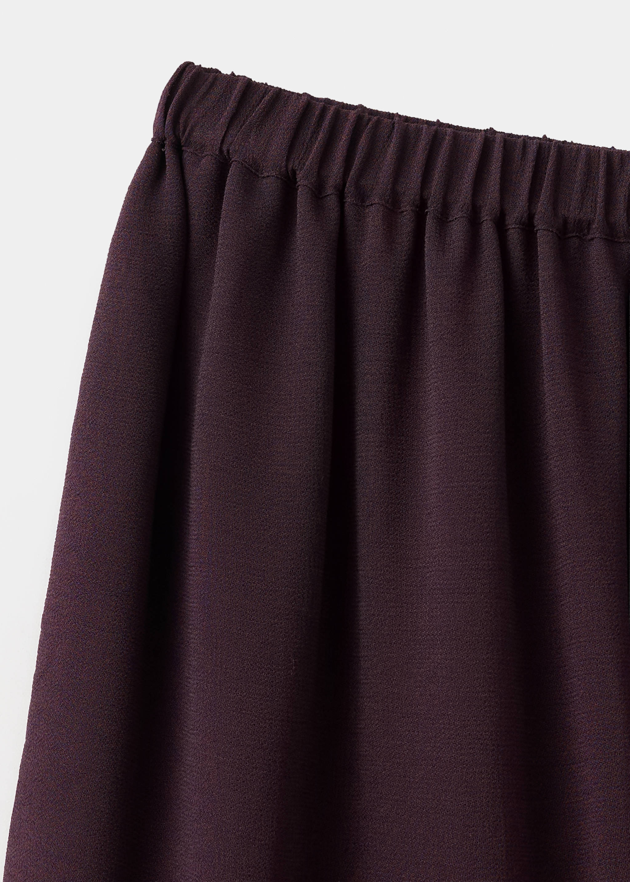 Close-up of a dark burgundy skirt elastic waistband