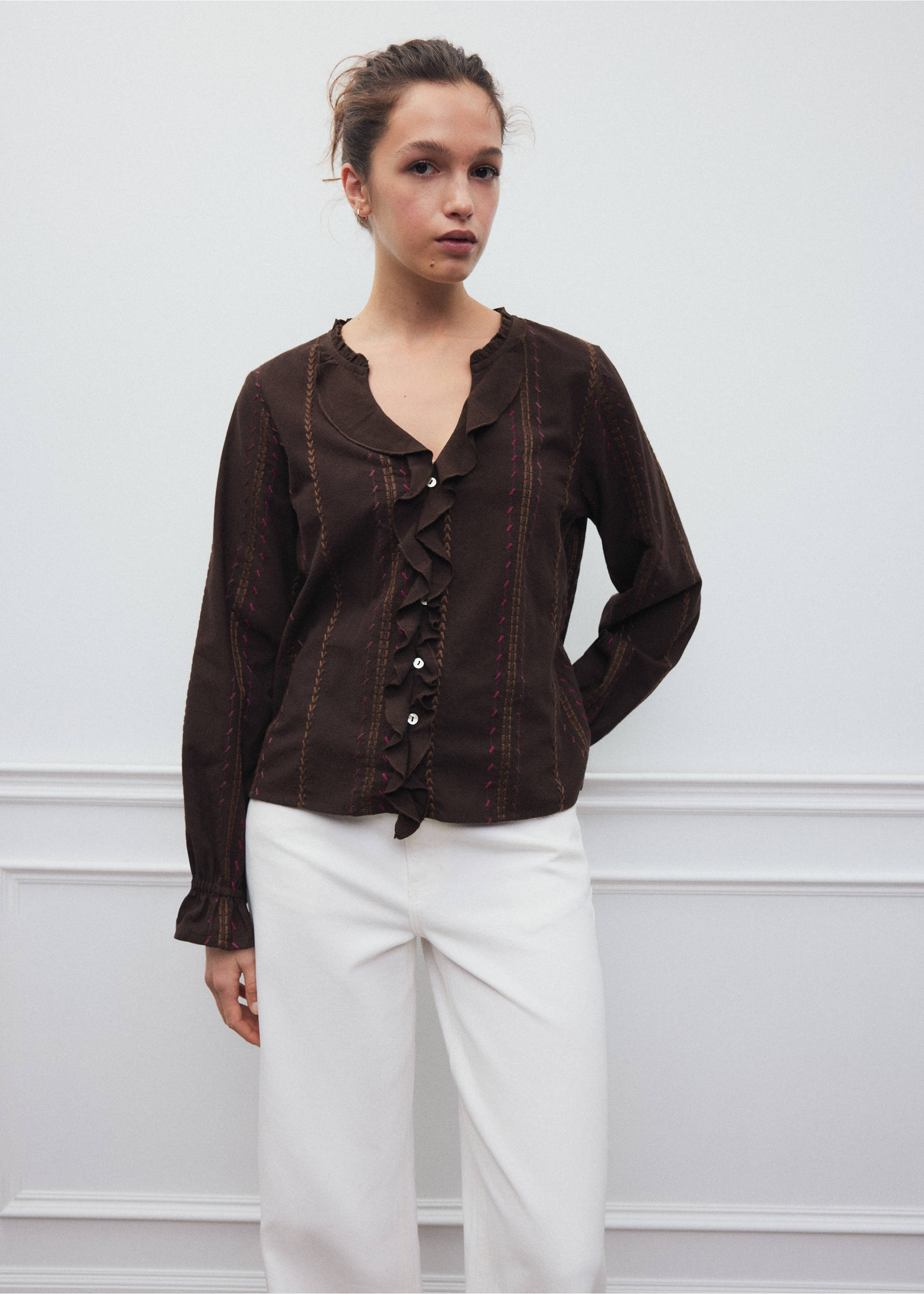 Dark brown shirt with vertical embroidery, ruffled V-neck, and button fastening, worn with white trousers., Brown. Ref: 37068276-00.