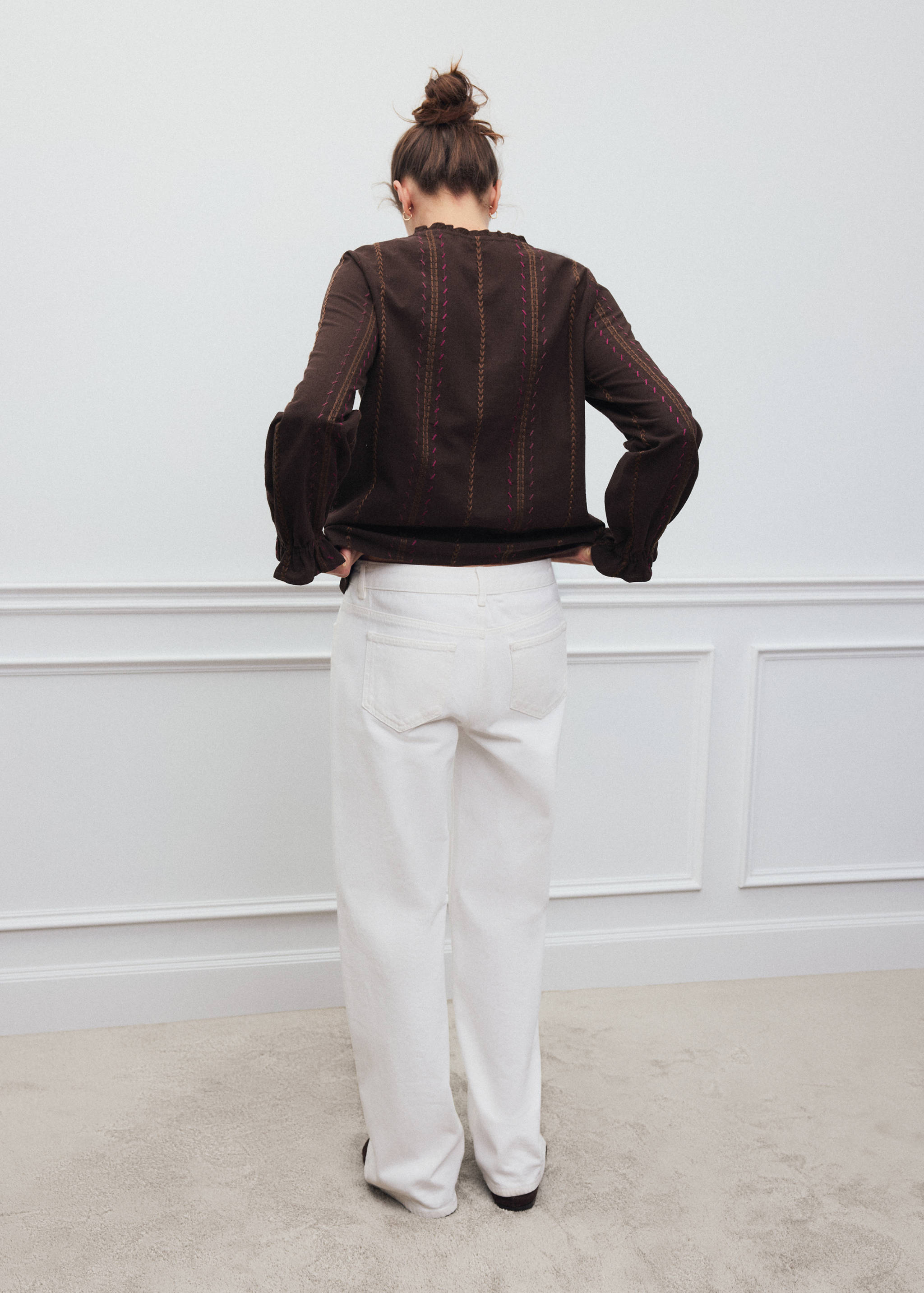 Dark brown shirt with vertical embroidery and ruffled trim, back view.