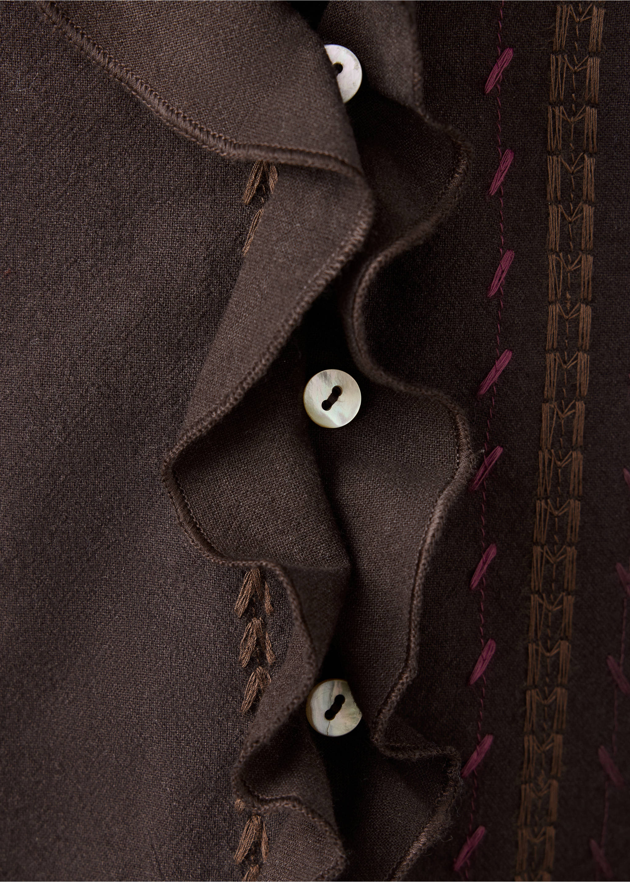 Close-up of a brown shirt with ruffles, shell buttons and embroidery., Brown. Ref: 37068276-00.