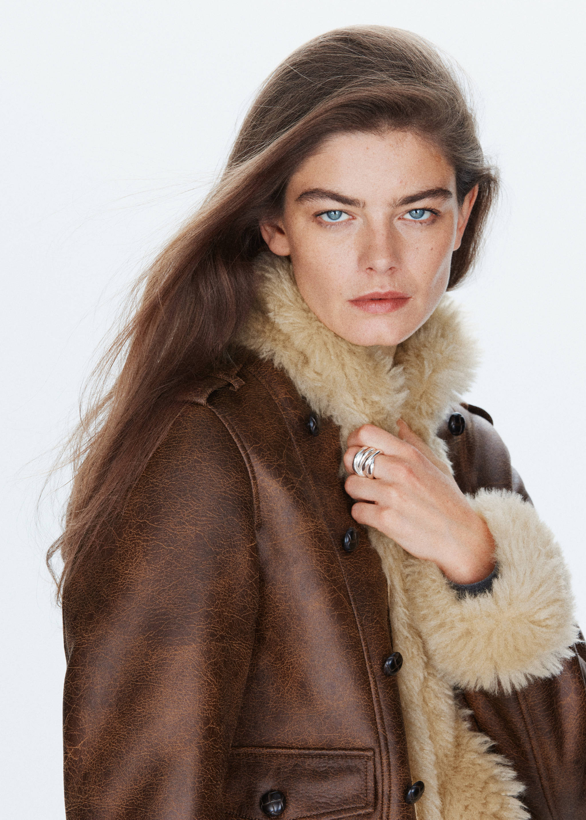 Brown faux-leather jacket with cream faux-shearling lining and dark buttons.