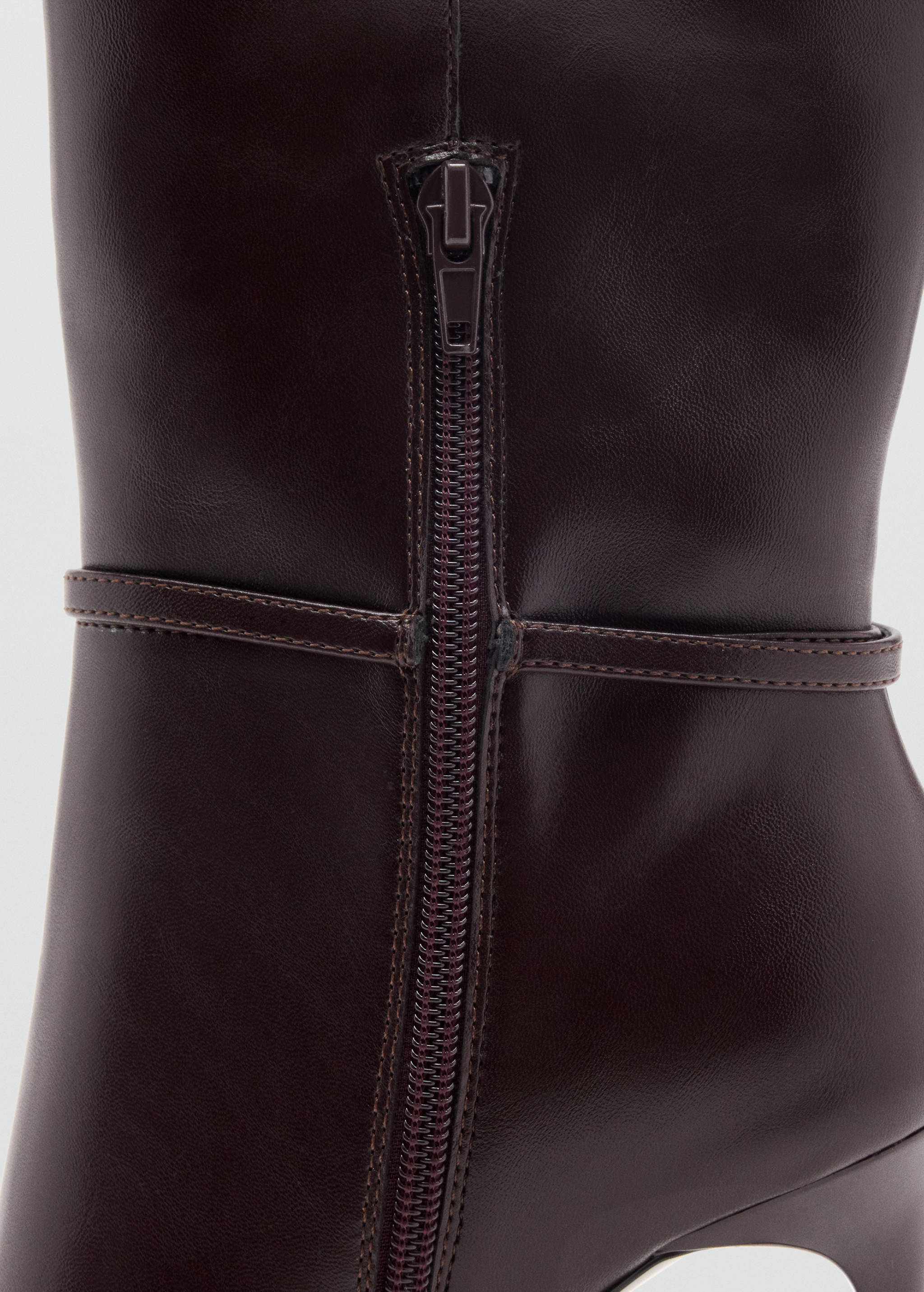 Close-up of the back zip detail on a dark burgundy boot.