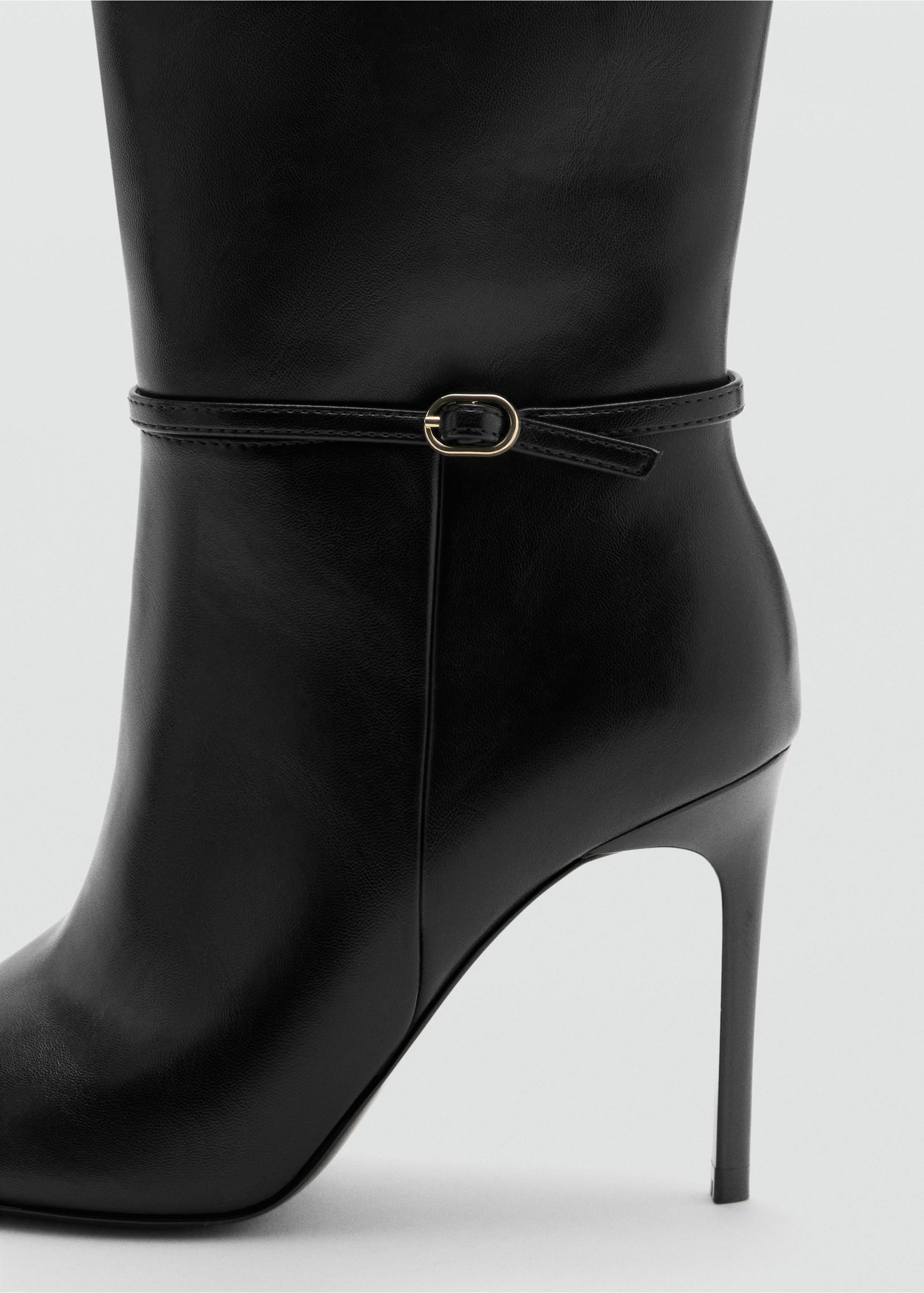 Close-up of a black leather heeled boot with a thin buckled ankle strap., Black. Ref: 37068279-00.