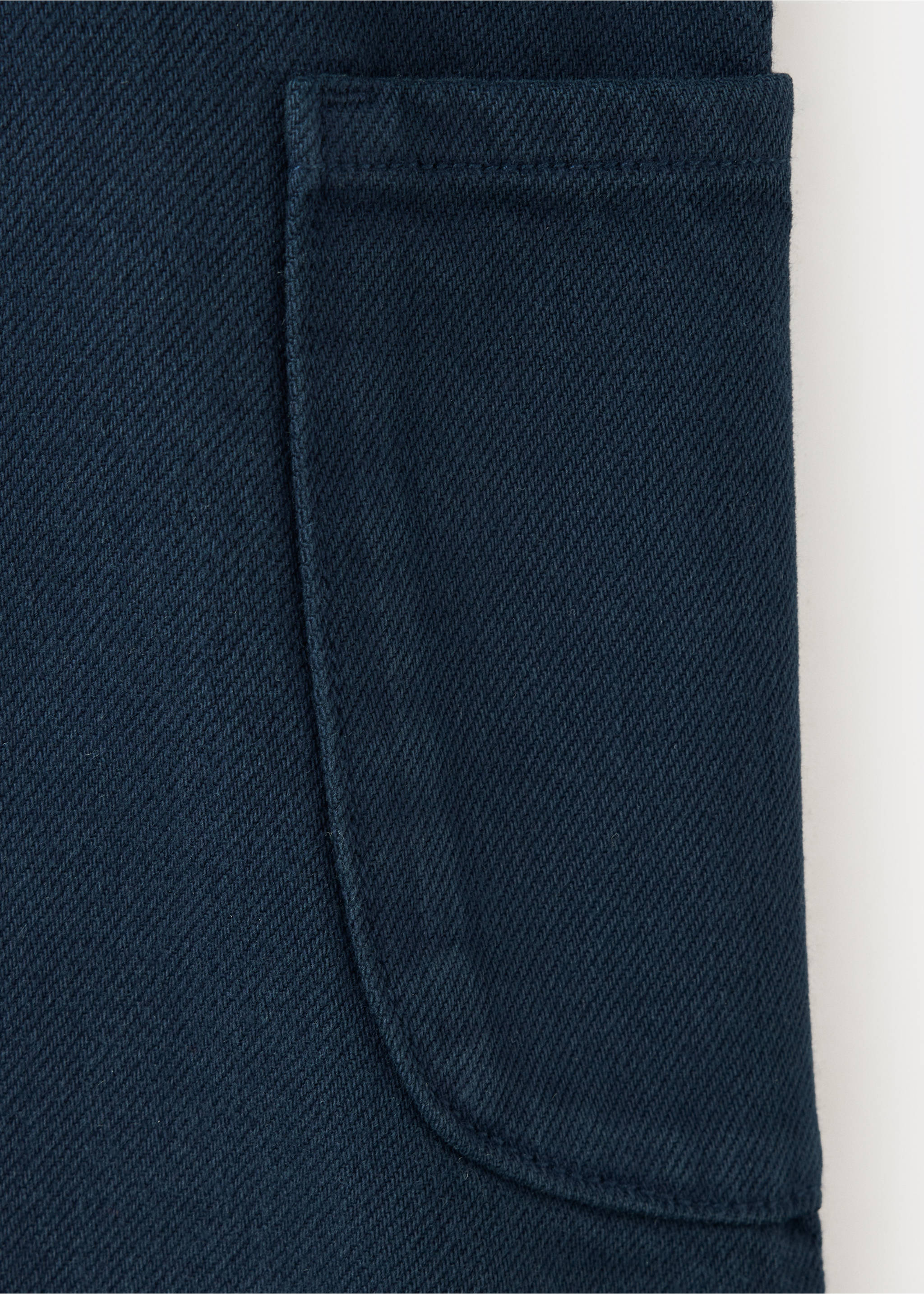 Navy blue denim fabric detail of a kids pinafore with a patch pocket., Navy. Ref: 37068284-00.