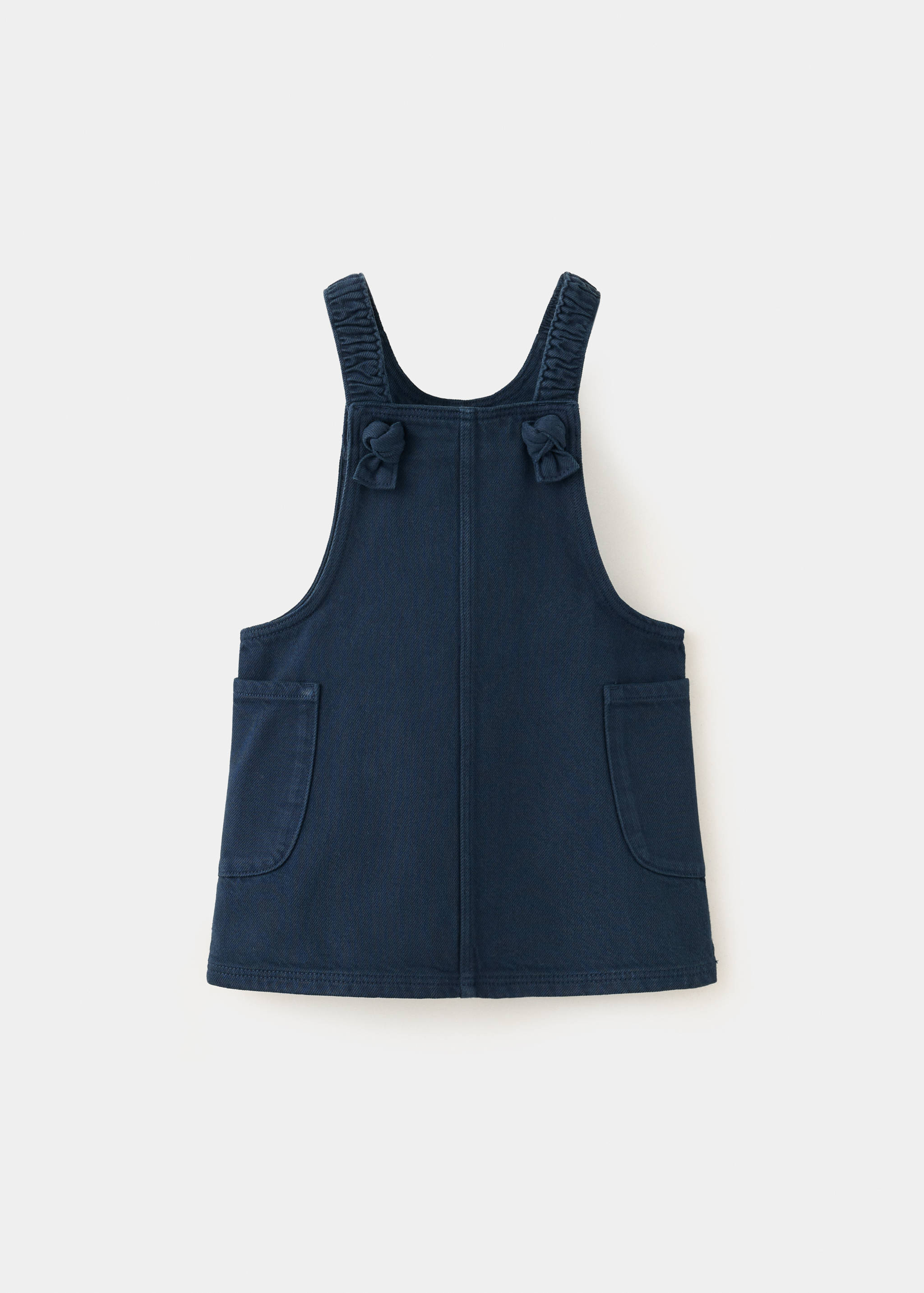 Dark blue denim pinafore dress with gathered shoulder straps and side pockets.