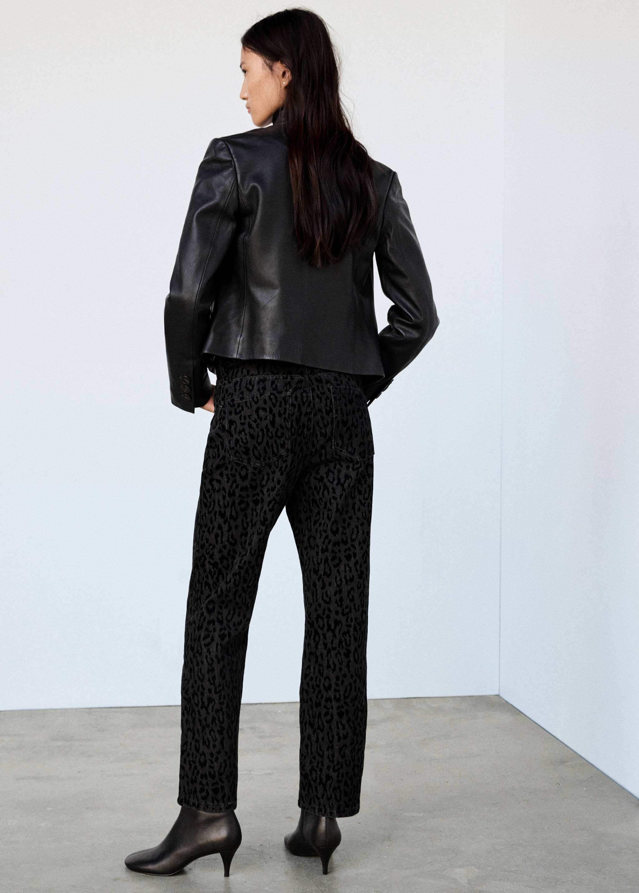 Black leopard print denim trousers in a straight fit, back view.