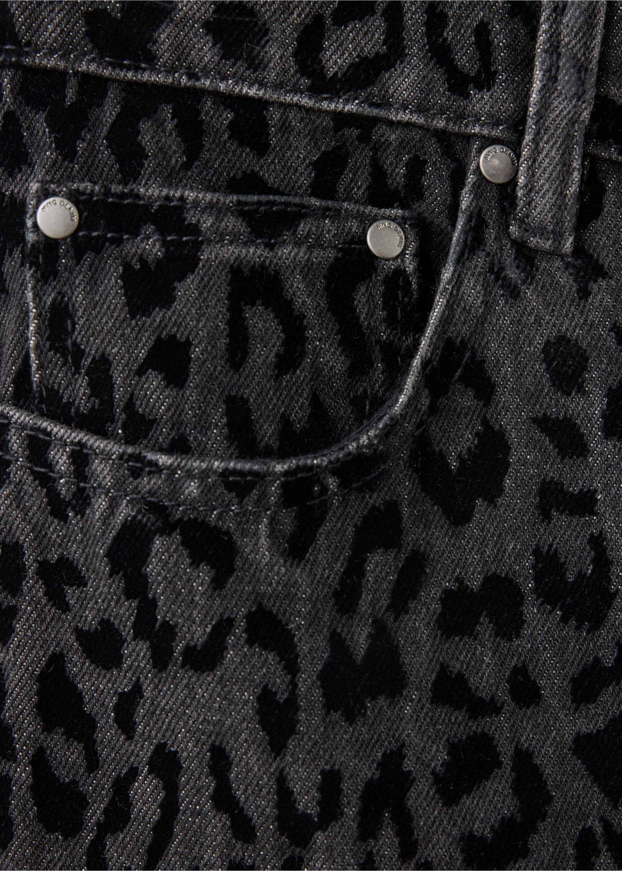 Close-up of grey denim trousers with a black animal print., Denim Grey. Ref: 37068285-00.