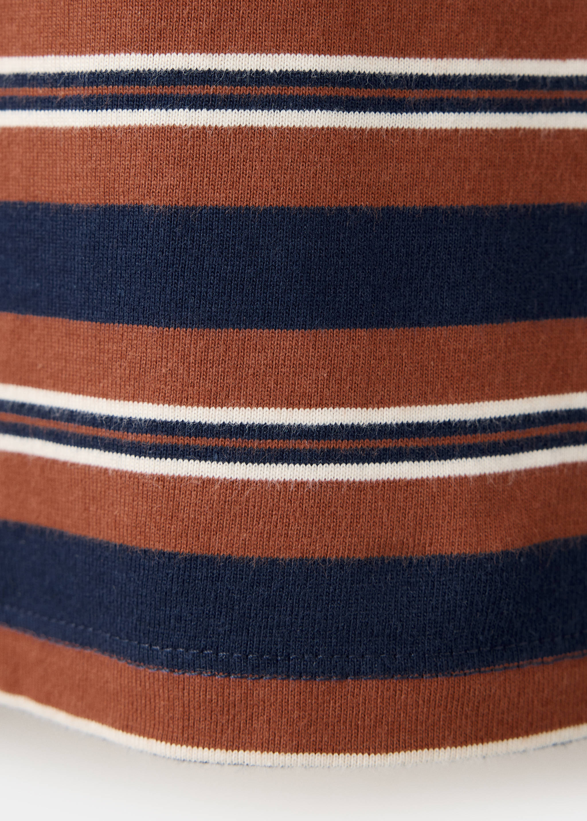Close-up of the fine-knit striped fabric of a polo shirt.