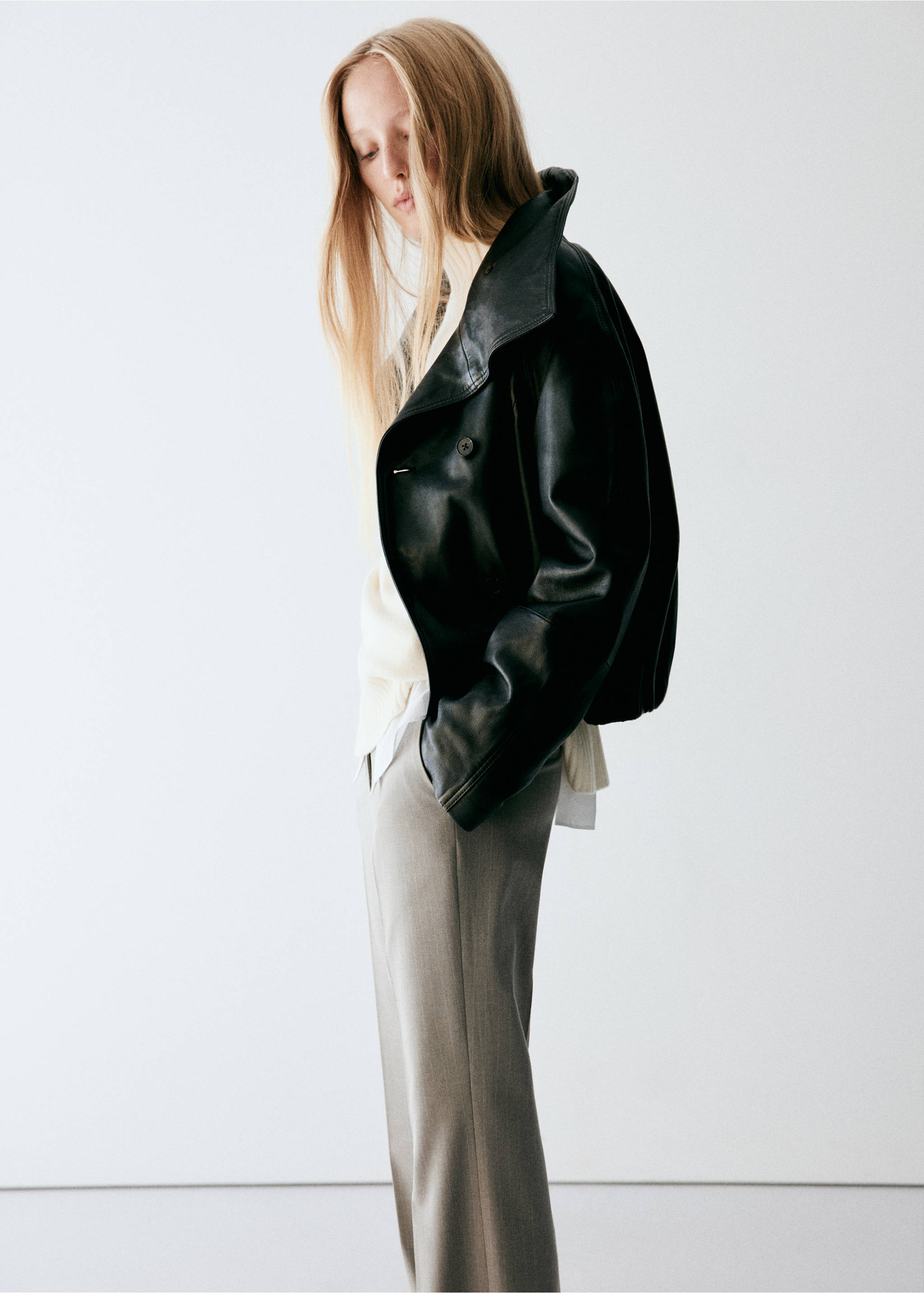 Grey trousers worn with a cream sweater and black leather jacket., Medium Brown. Ref: 37068639-00.