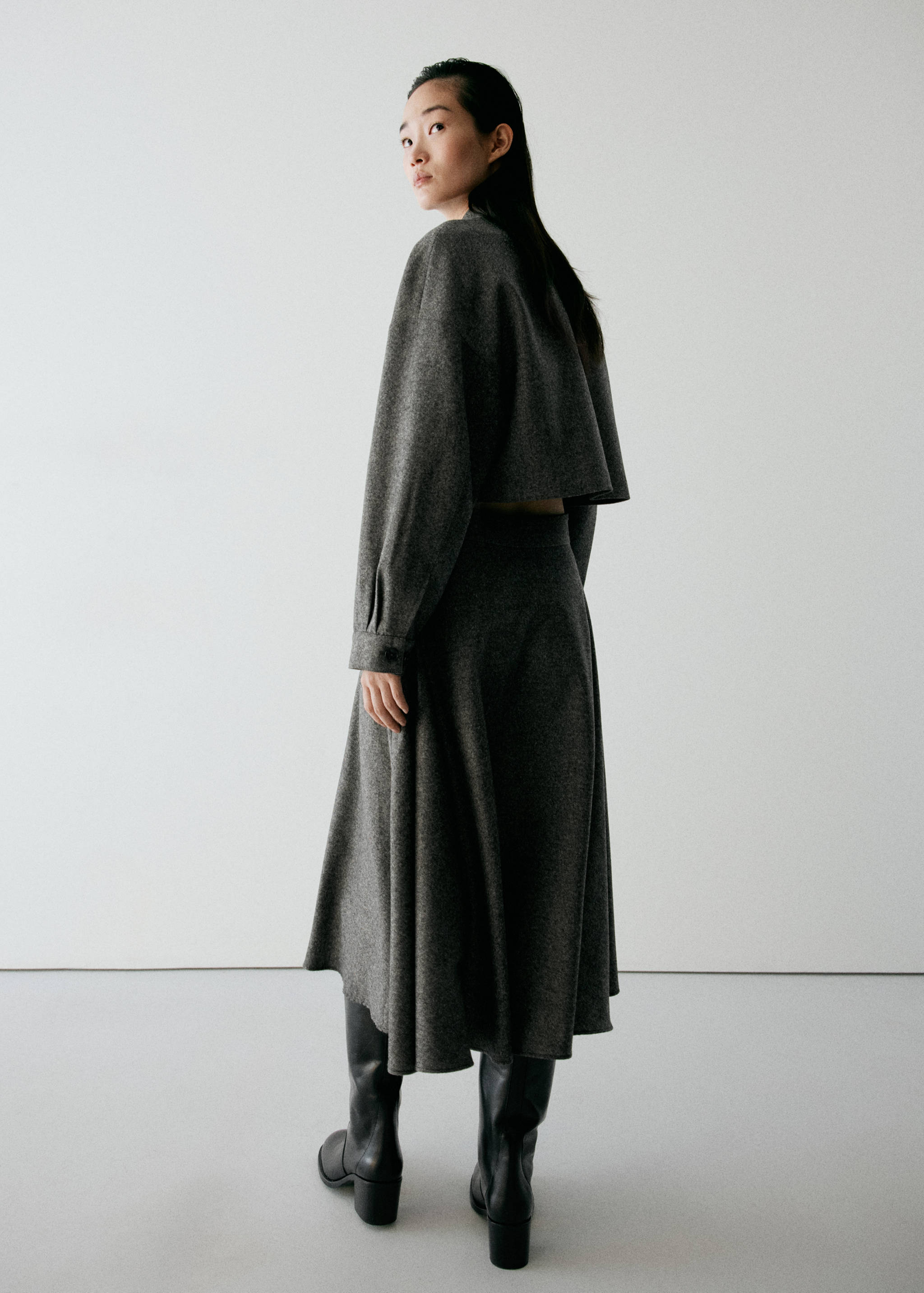 Dark grey midi-length flared skirt, back view.
