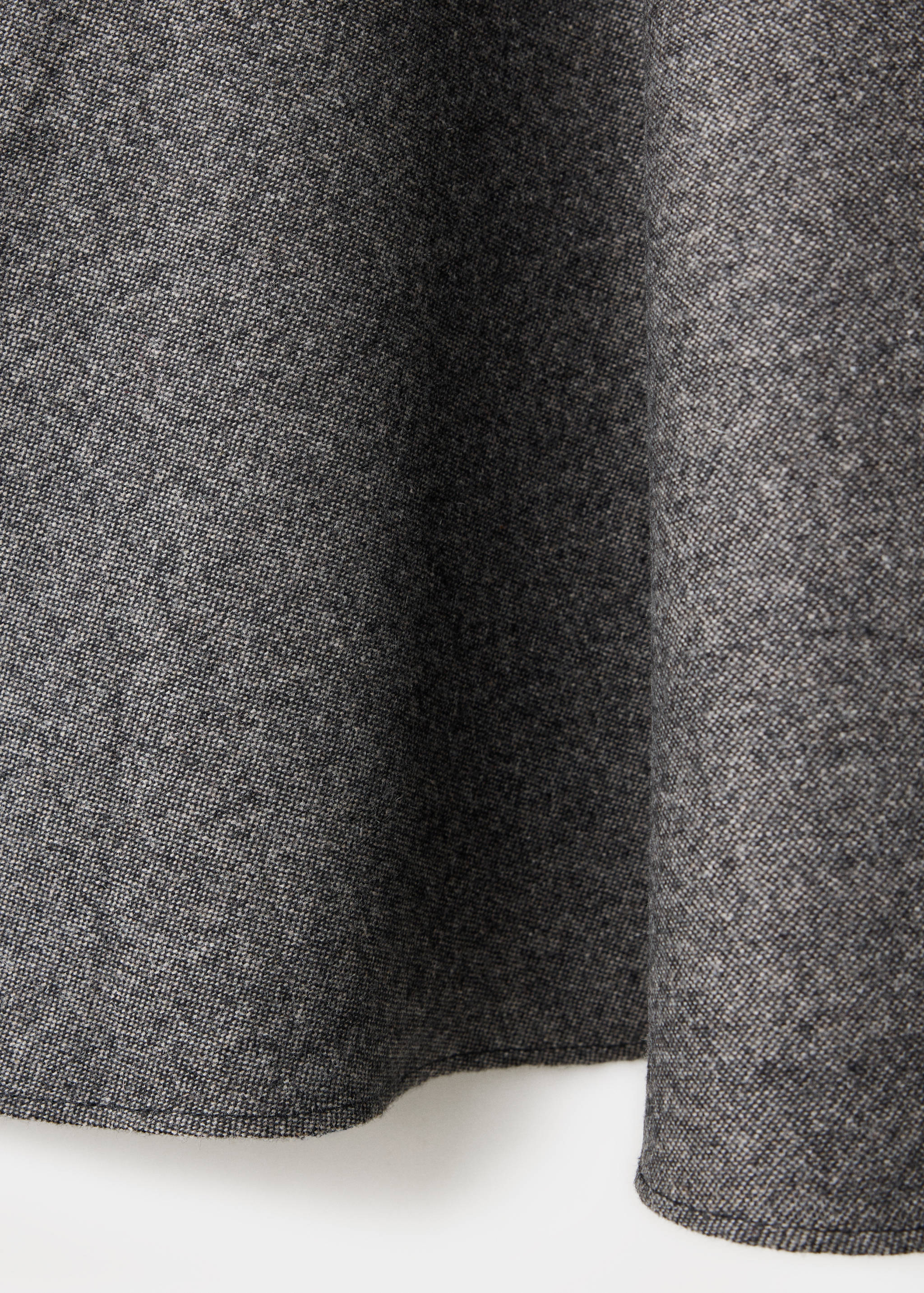 Grey textured fabric detail of a skirt