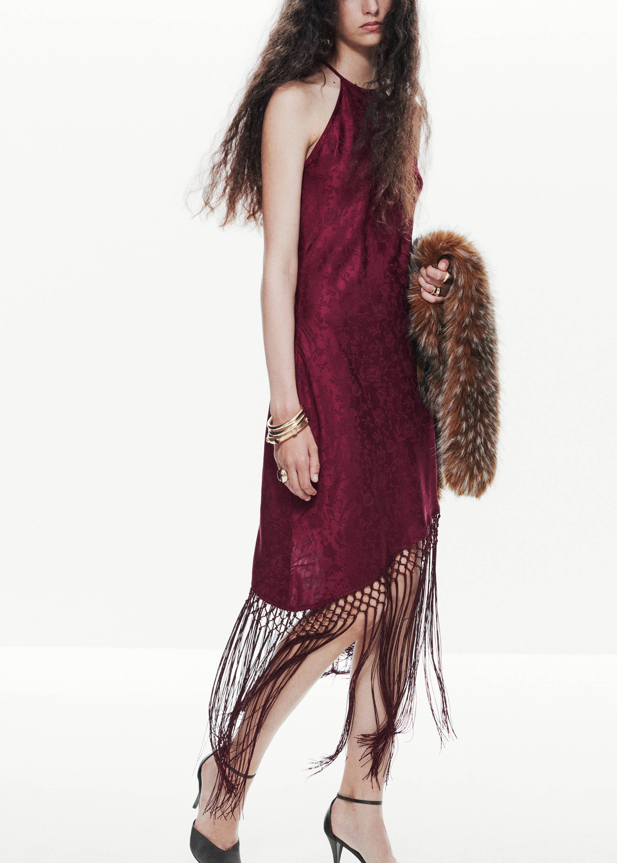 Deep red patterned halter dress with an asymmetric fringed hem.