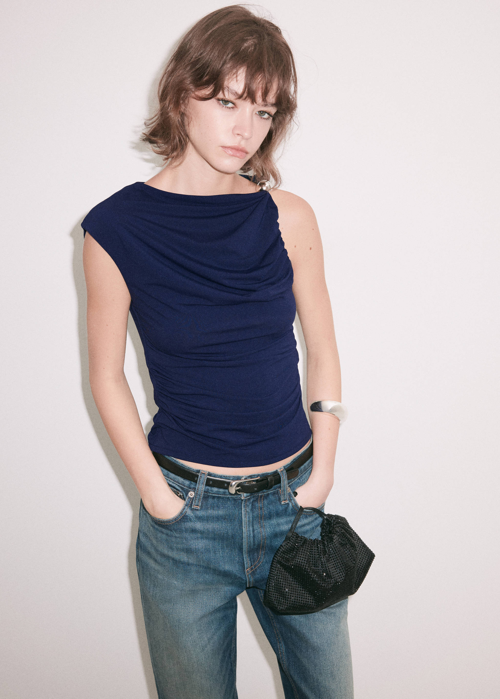 Dark blue draped top with a boat neck and cap sleeves.