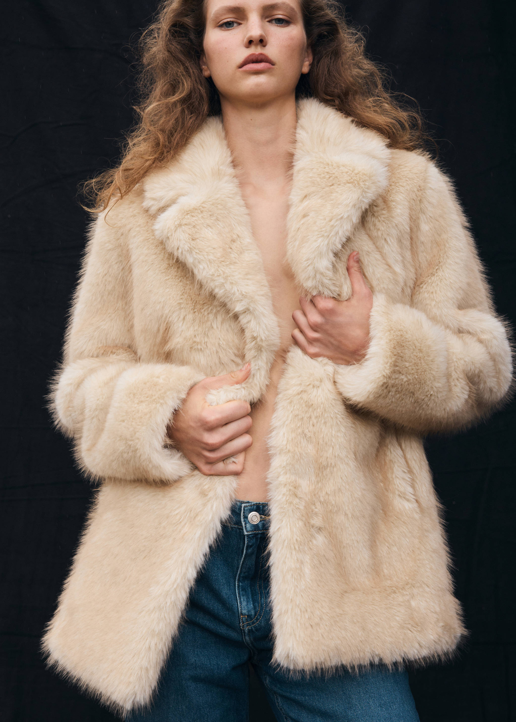 Cream faux-fur coat with a wide lapel collar.
