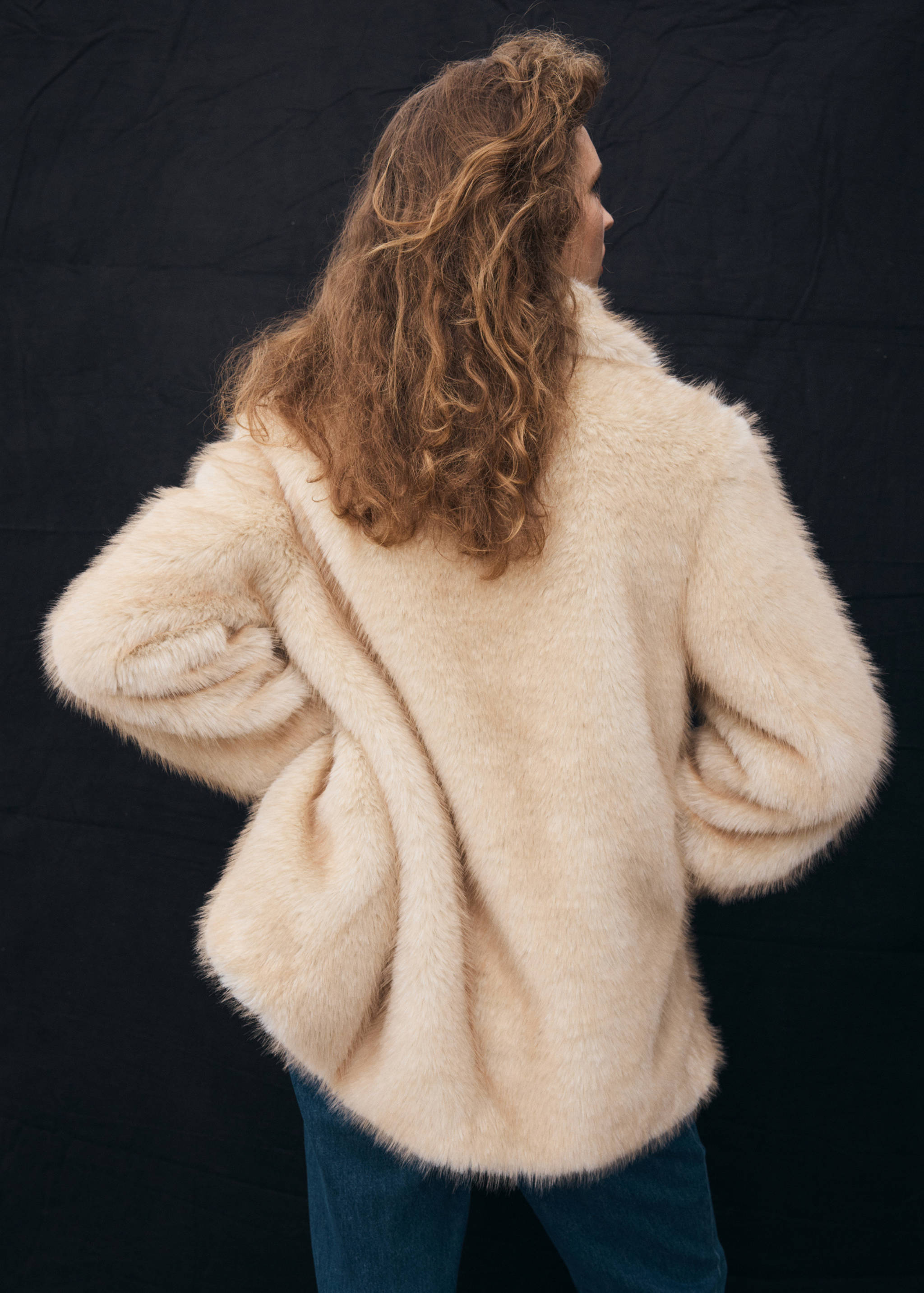 Cream faux-fur coat, back view.