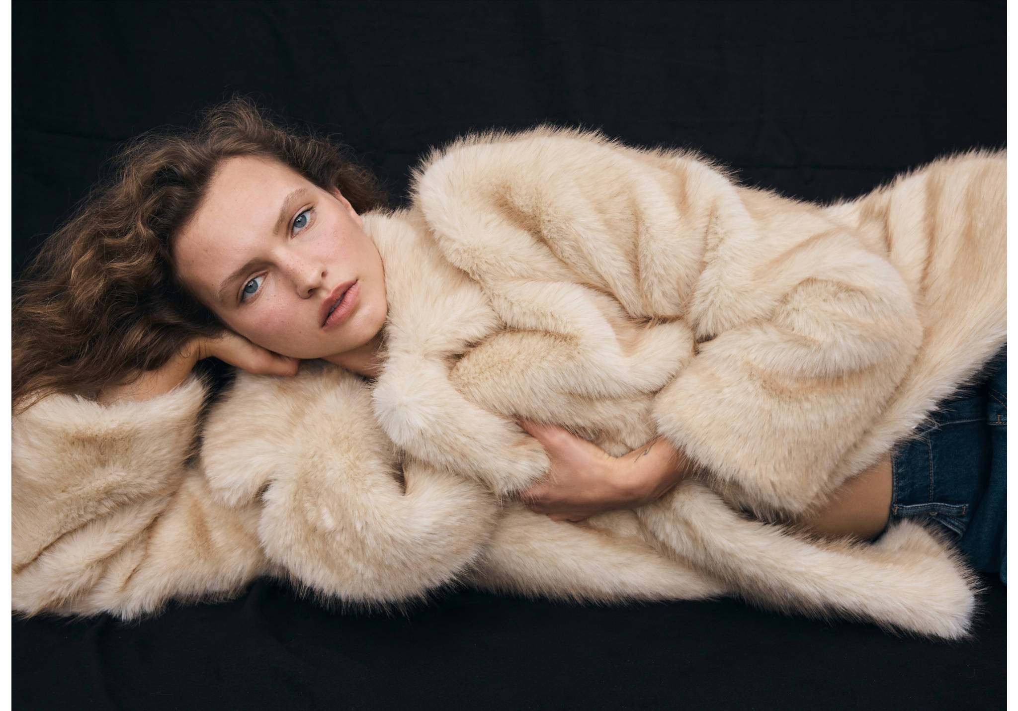 Cream faux-fur coat with a wide lapel collar.