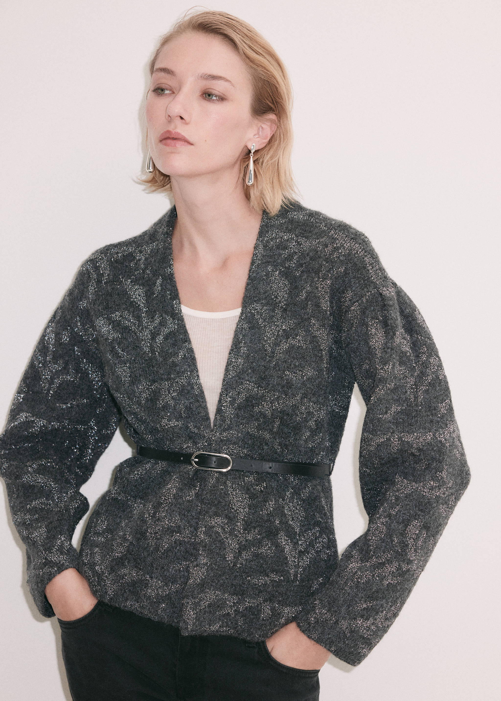 Dark grey metallic patterned knit cardigan with a V-neck and a slim black waist belt.