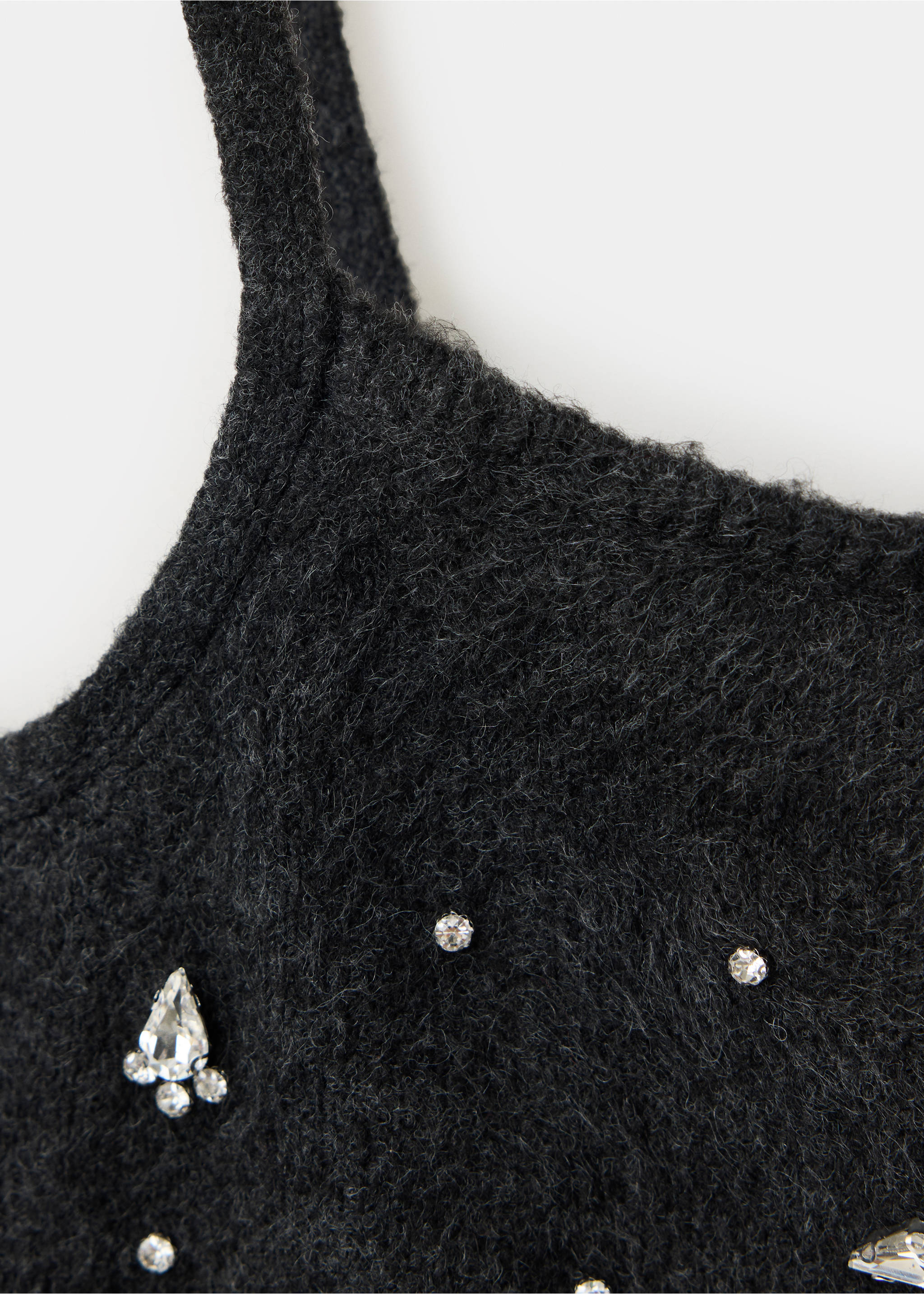 Close-up of a black textured knit top with rhinestone embellishments., Charcoal. Ref: 37069125-00.