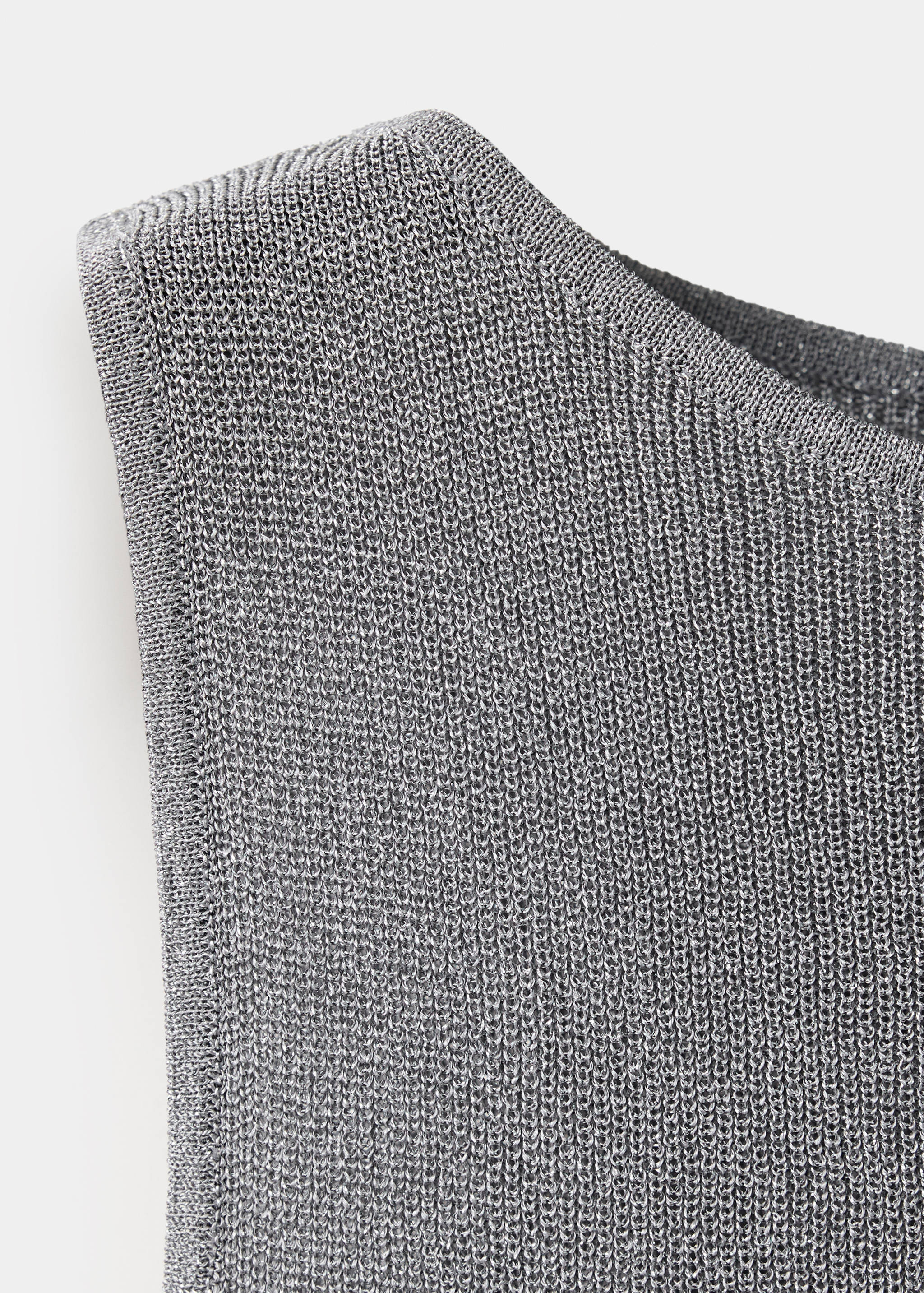 Close-up of a grey metallic knit top showing the fine ribbed texture.