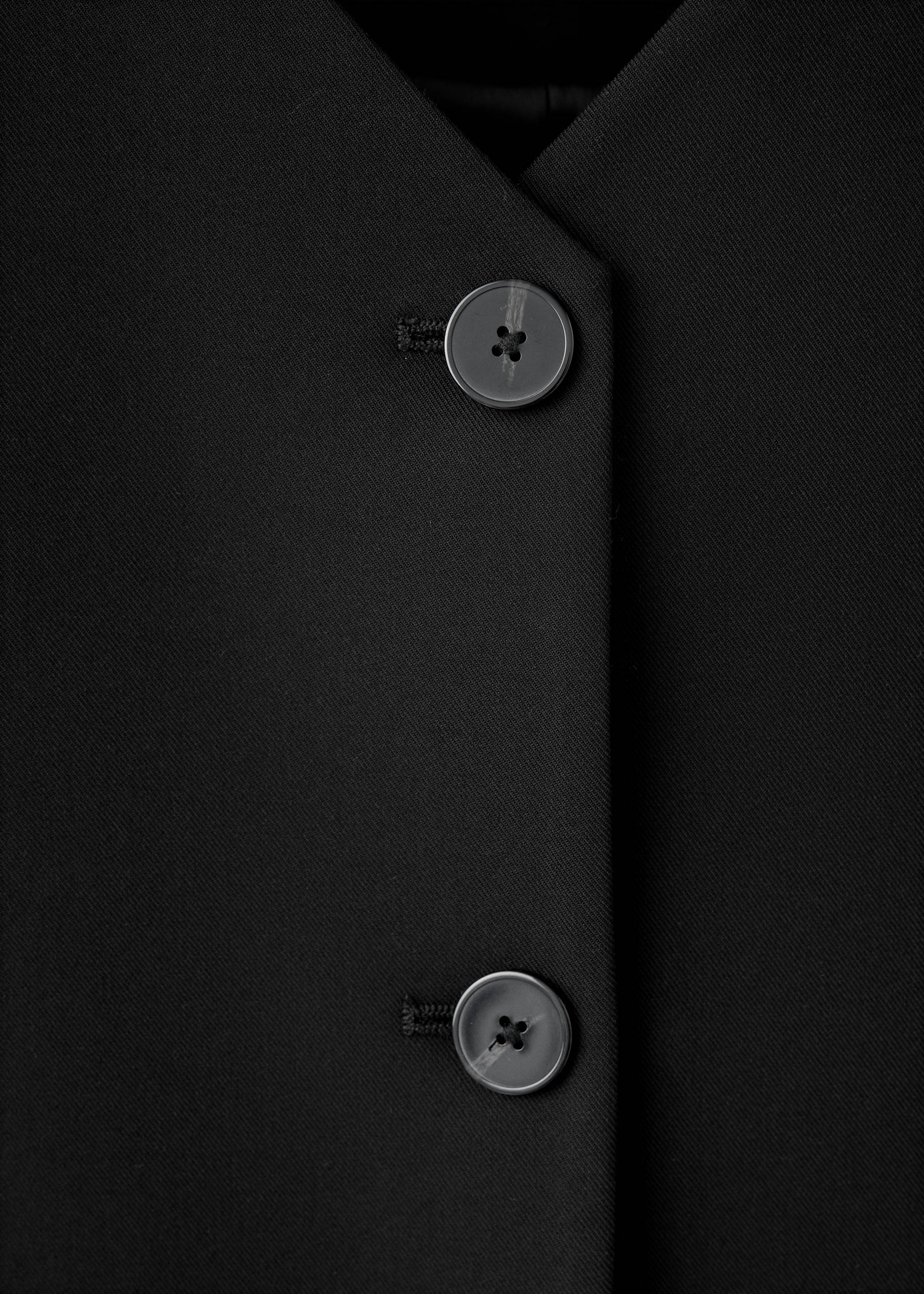 Black dress V-neck button detail.