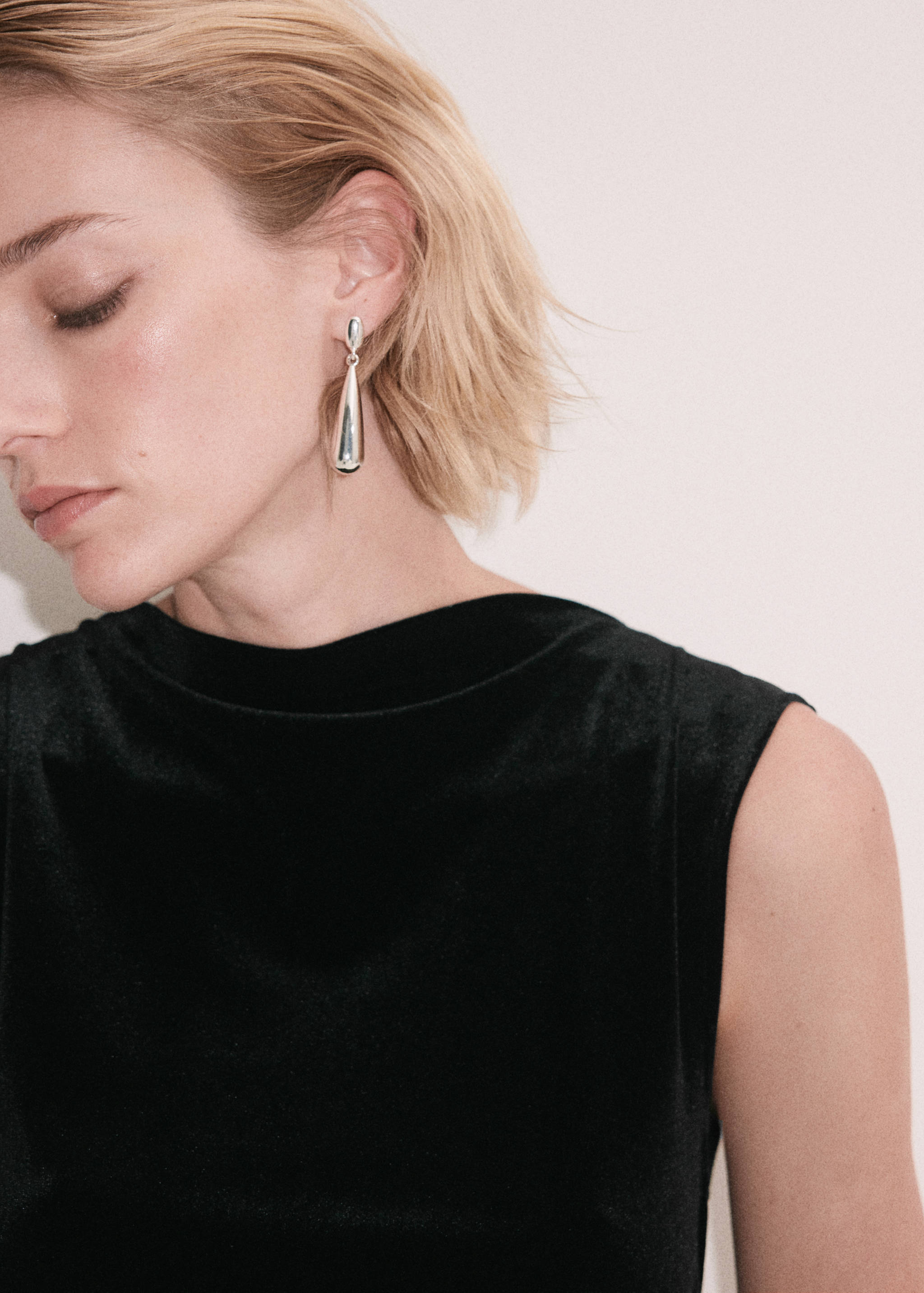 Close-up of a black sleeveless dress with a high neckline.
