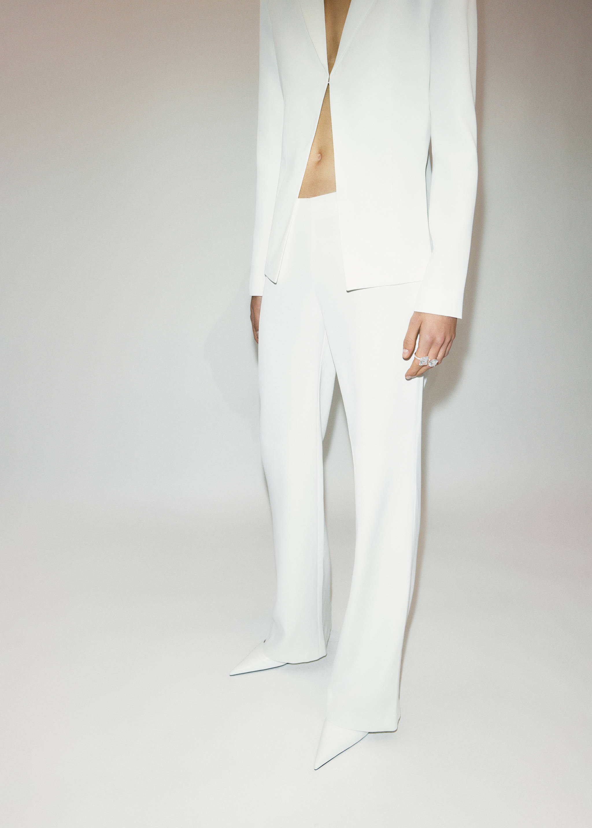 White pointed shoes worn with a matching white suit.