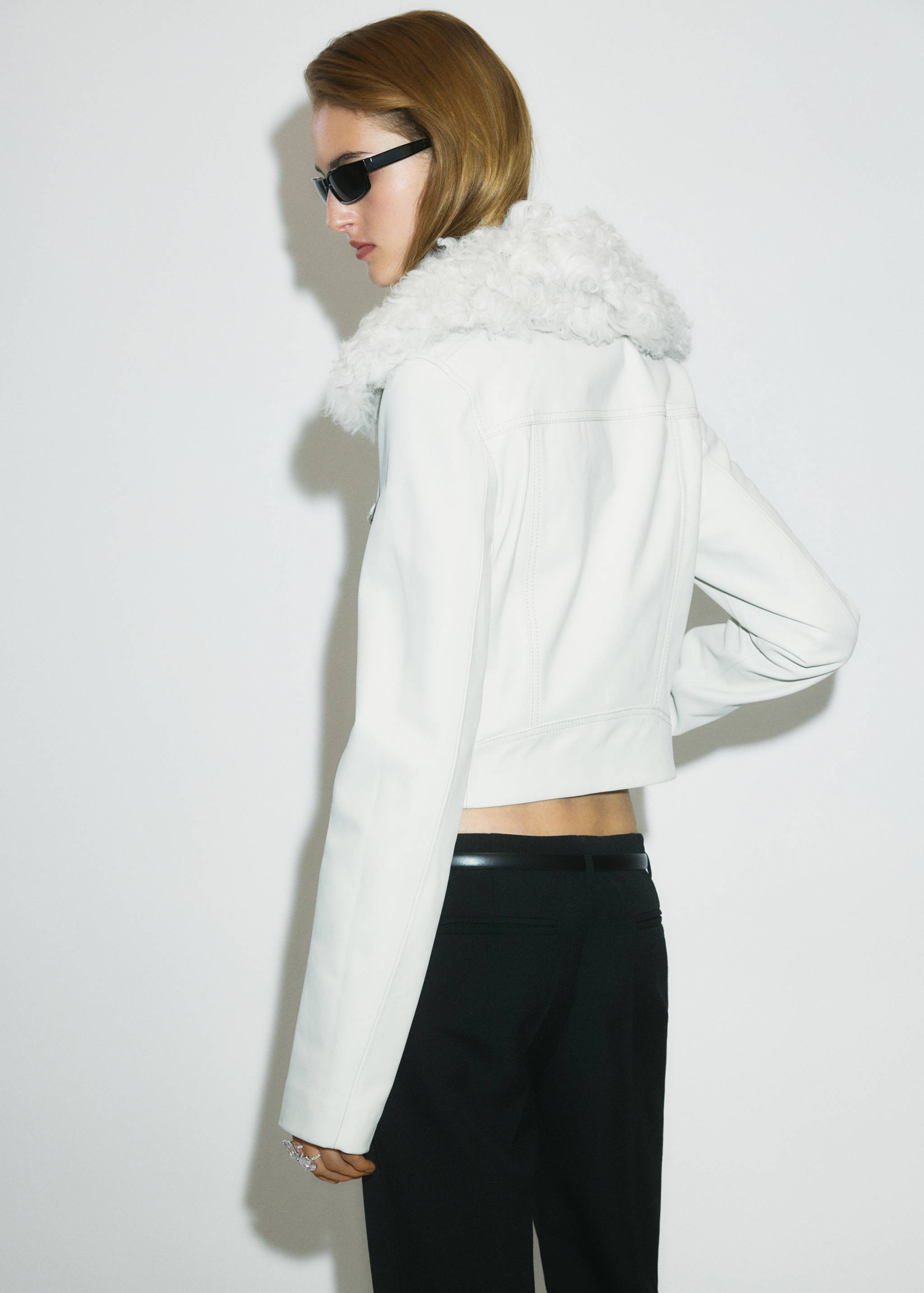 White cropped jacket with faux-fur collar, back view.