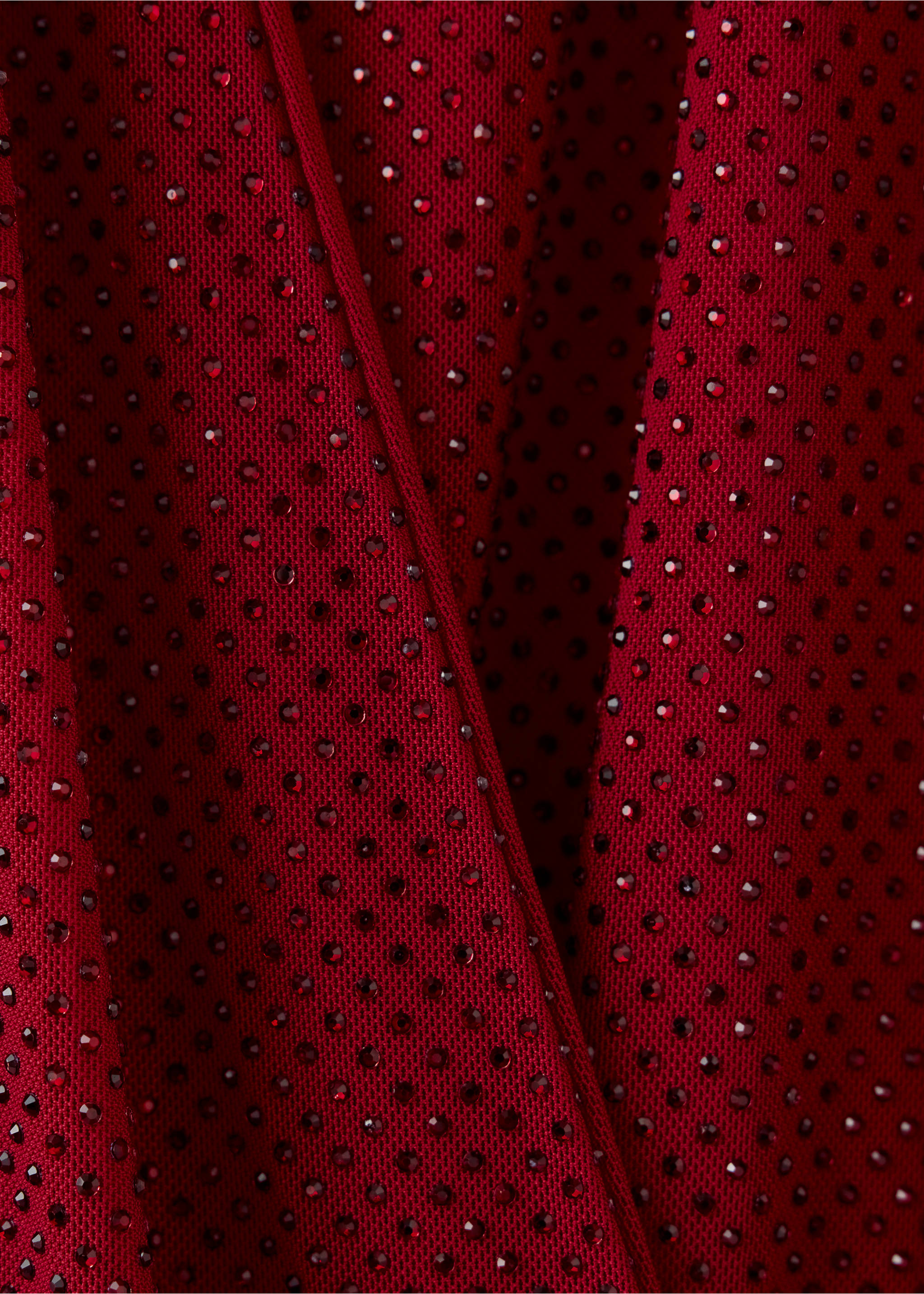 Close-up of a red rhinestone-embellished dress detail., Red. Ref: 37069144-00.