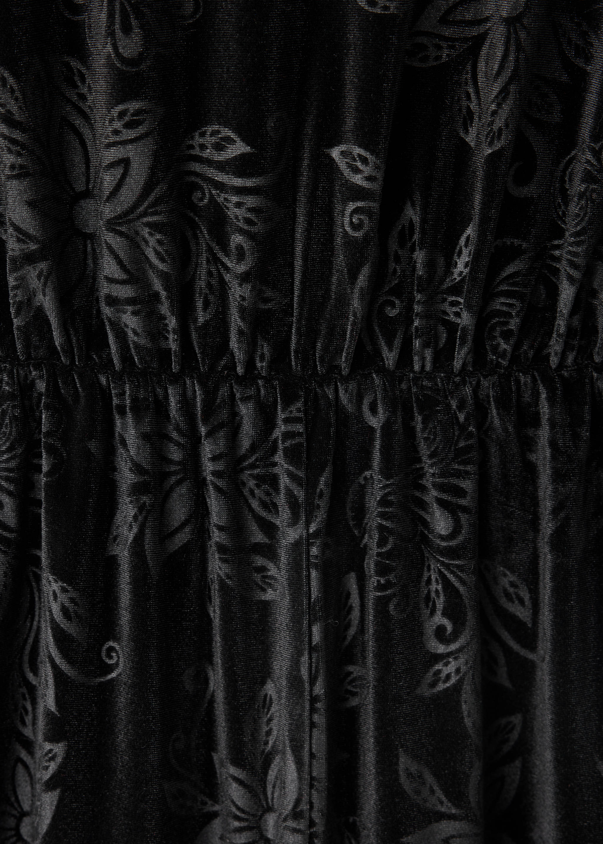 Black jumpsuit detail with tonal floral pattern and elasticated waist