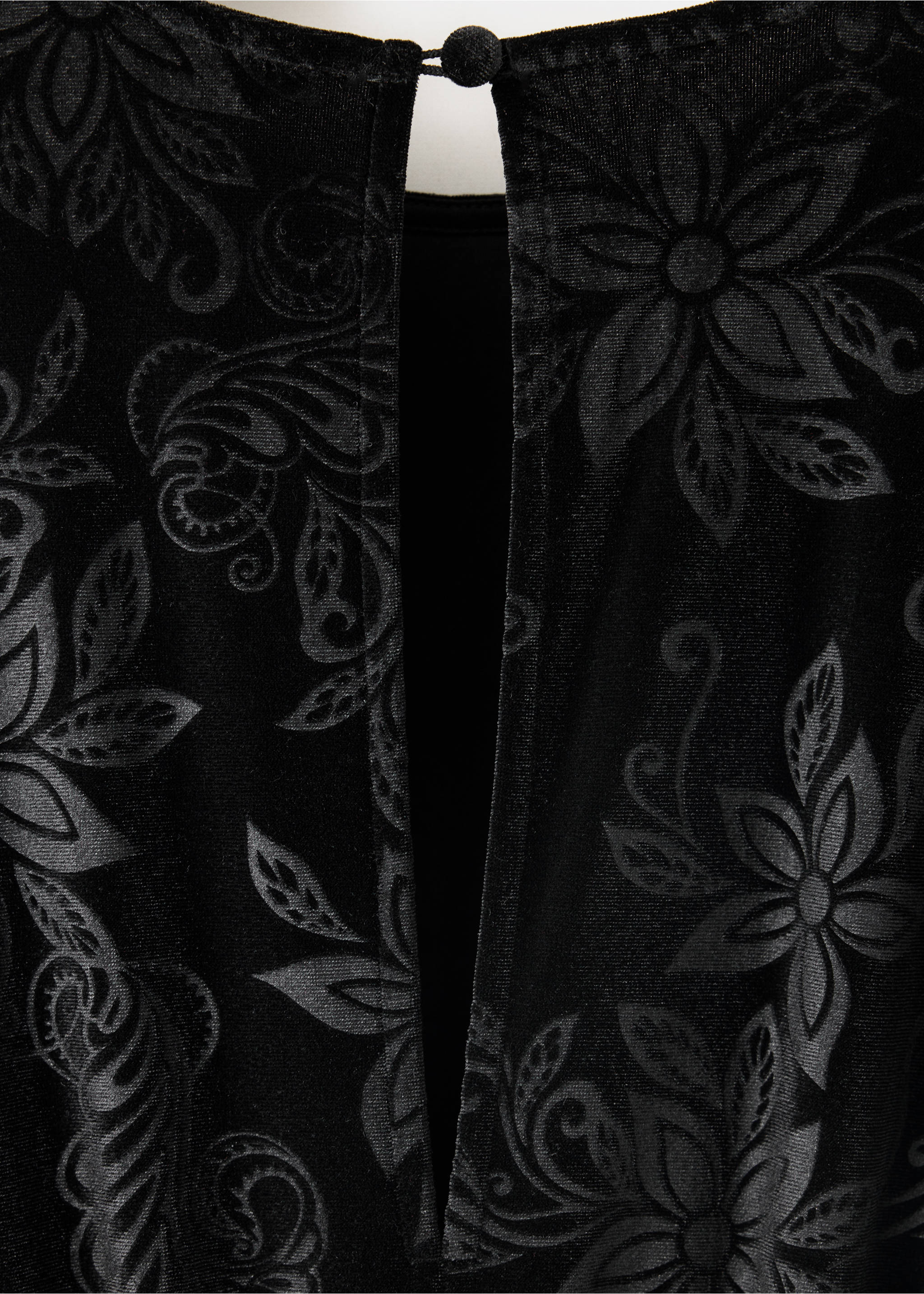Close-up of black velvet jumpsuit fabric with tonal floral burnout pattern., Black. Ref: 37069208-00.