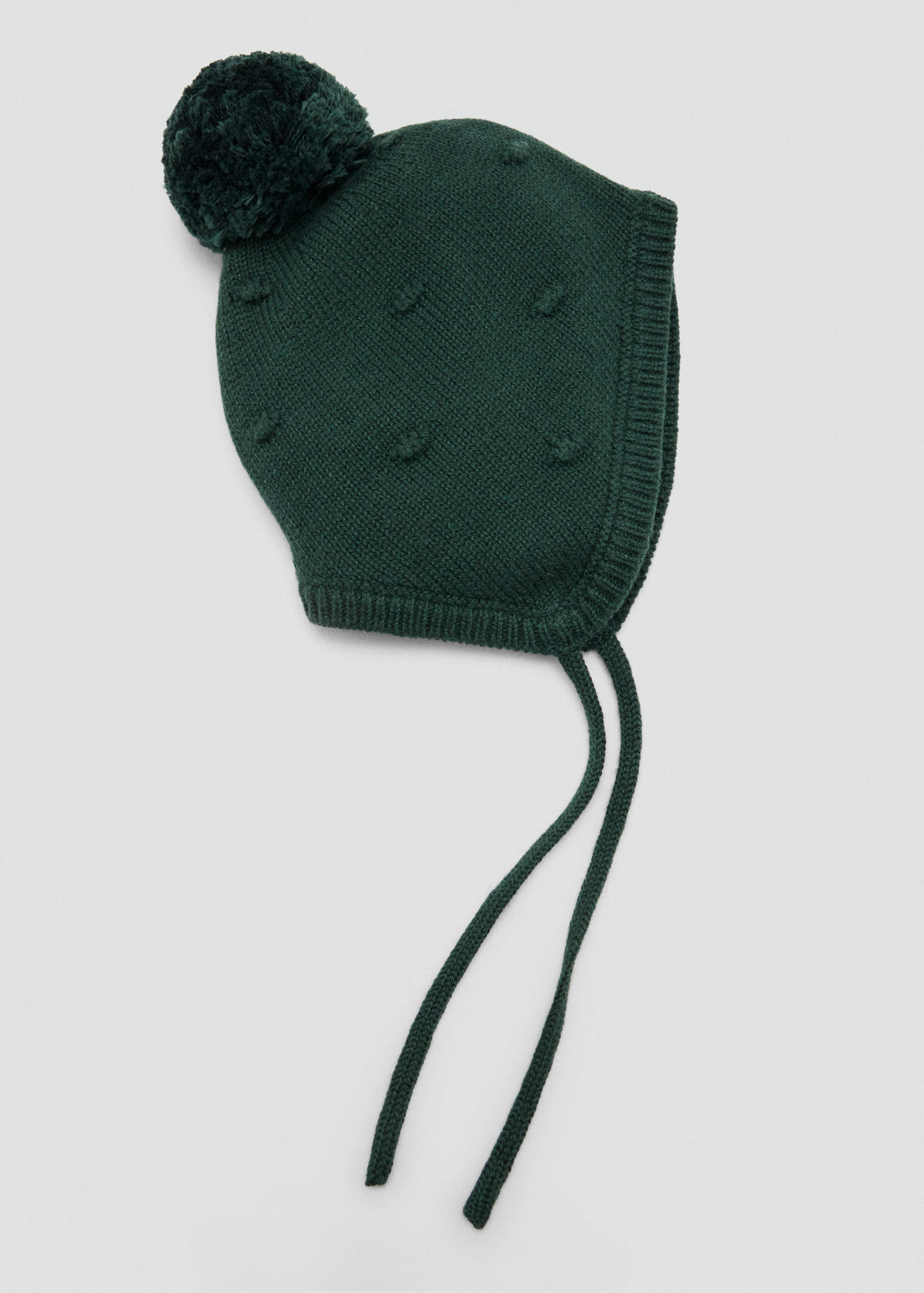 Dark green knit bonnet with a pom-pom, textured bobbles, and chin ties