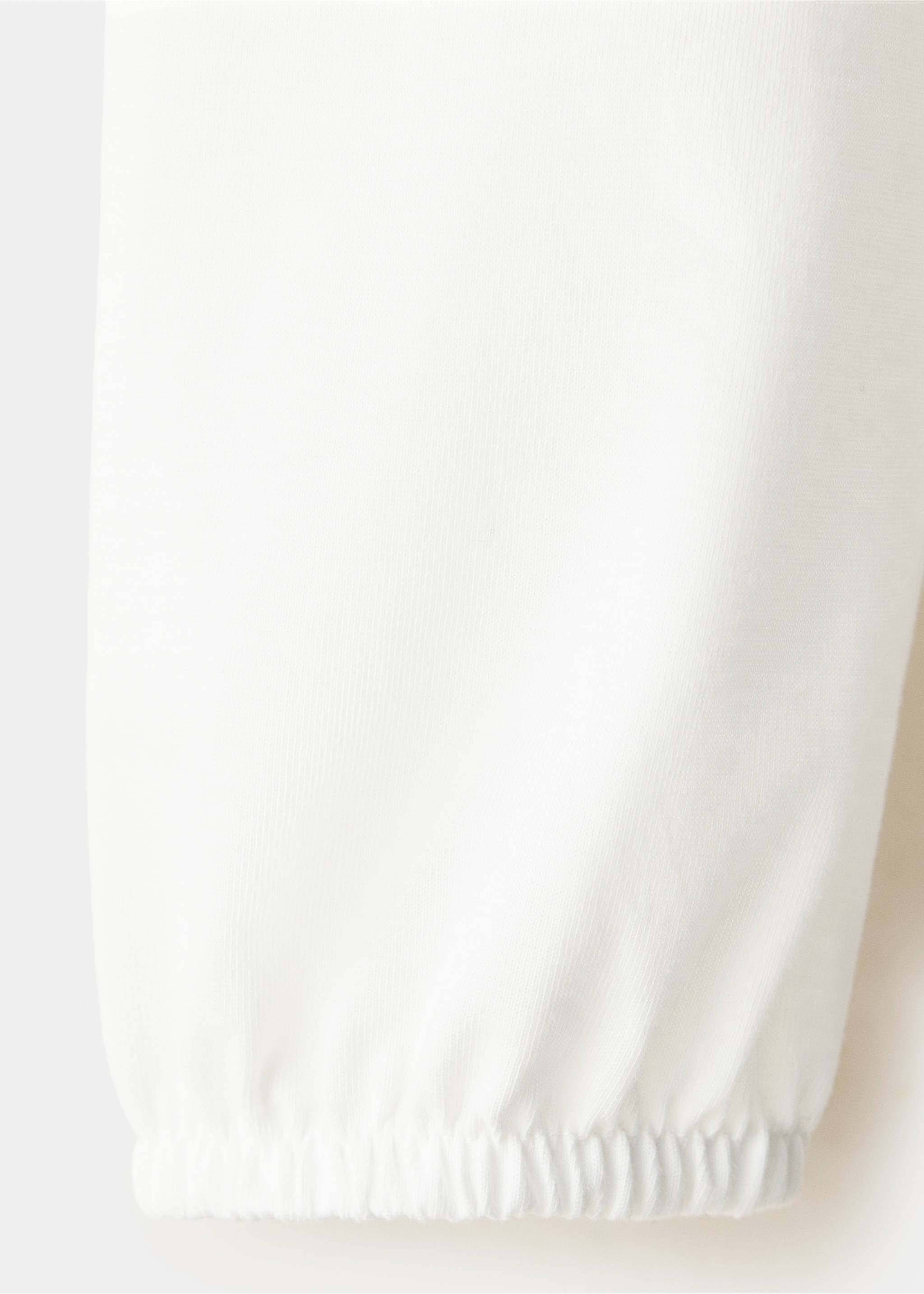 Close-up of a white t-shirt sleeve with an elasticated cuff., Off White. Ref: 37069222-00.