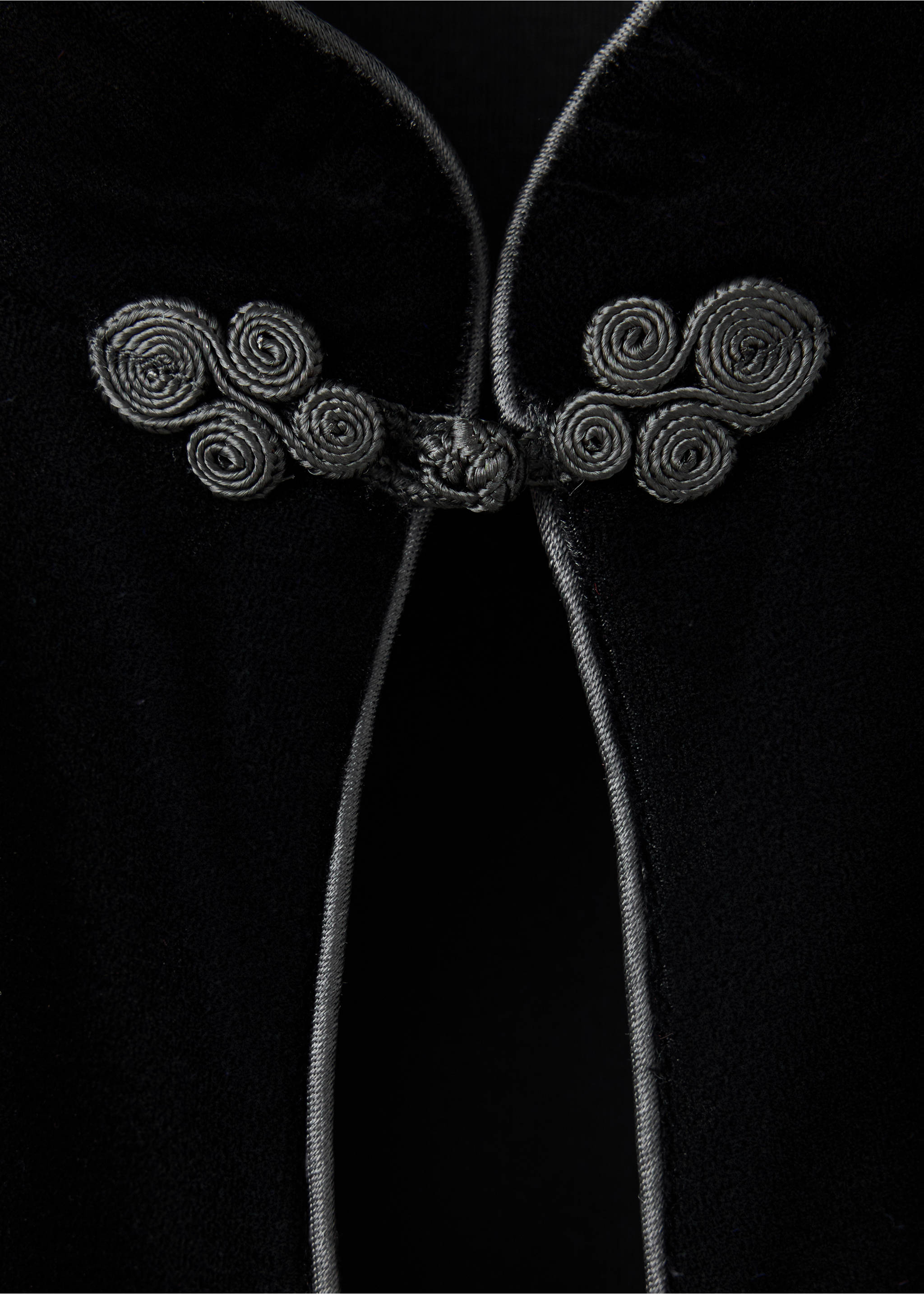 Black dress detail featuring decorative knotted frog closures., Black. Ref: 37069230-00.