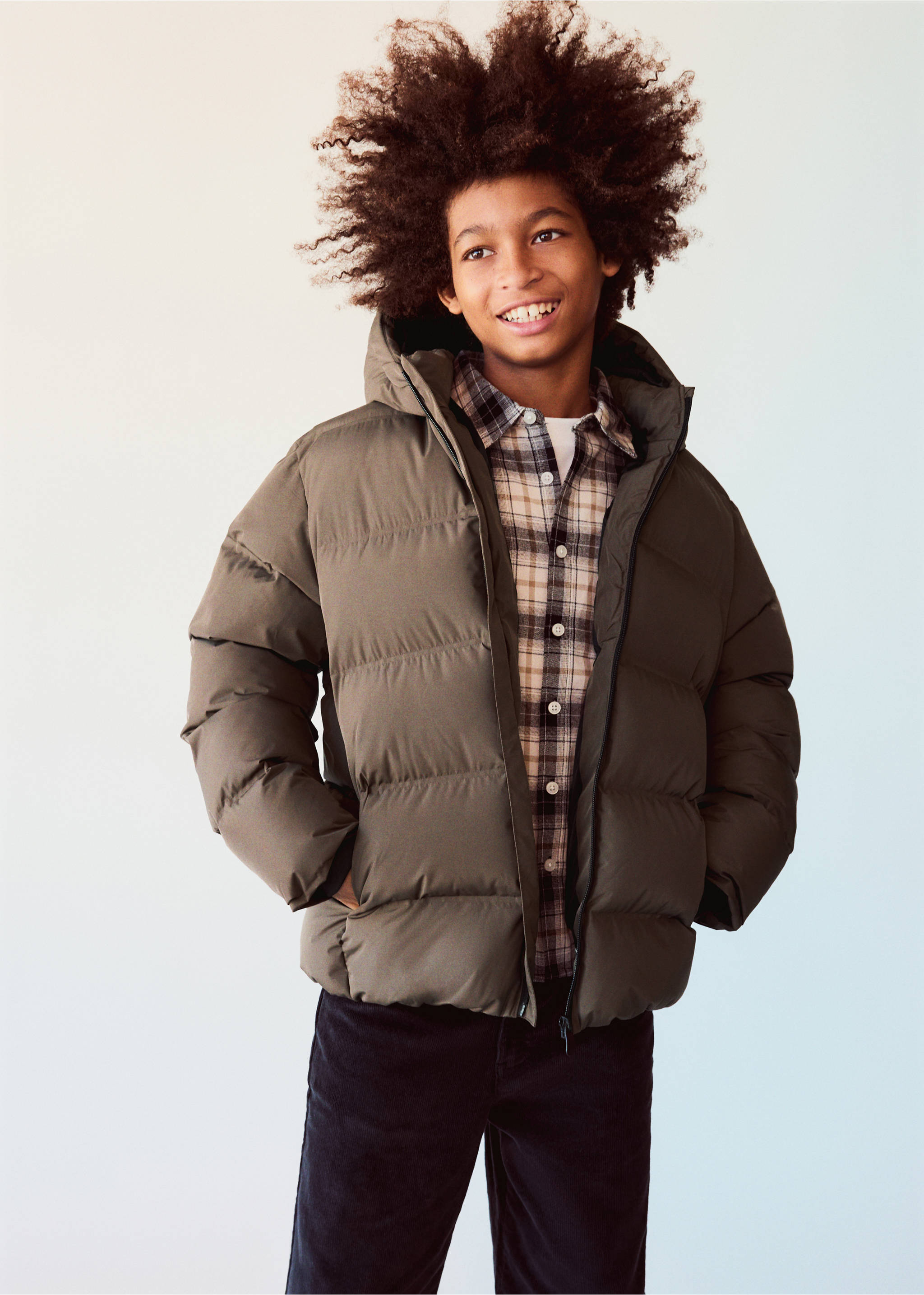 Olive green quilted anorak worn with a plaid shirt and dark trousers., Brown. Ref: 37071388-01.