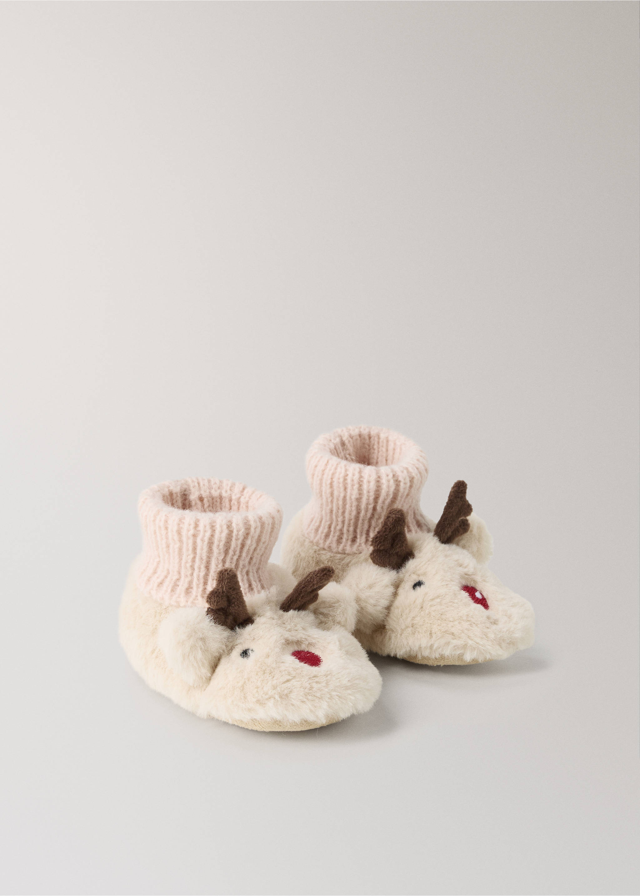 Fluffy off-white reindeer slippers with ribbed pink cuffs, brown antlers, and embroidered facial details., Sand. Ref: 37071538-00.