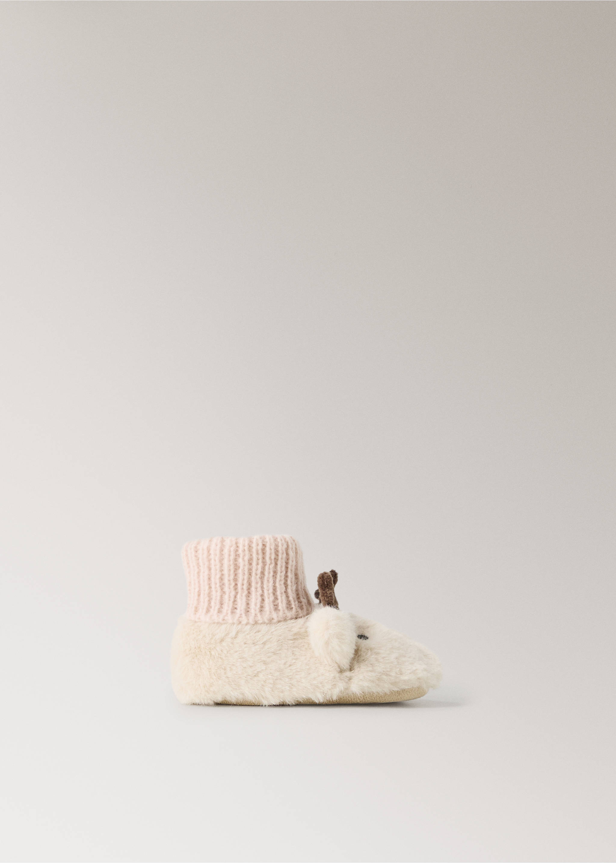 Cream faux-fur home slipper bootie with a pink ribbed cuff and deer ear and antler details., Sand. Ref: 37071538-00.