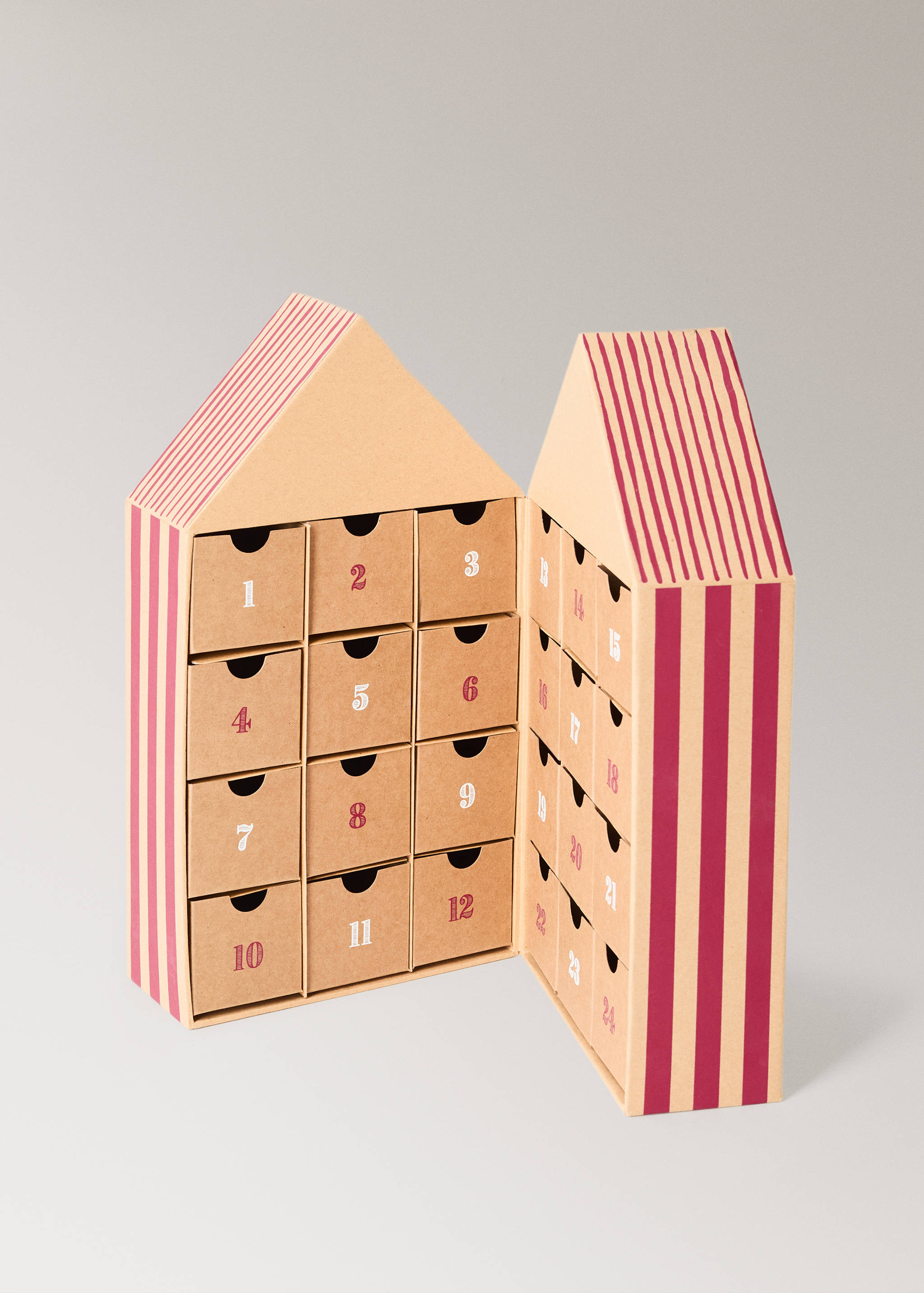 House-shaped cardboard advent calendar with pink stripes and twenty-four numbered drawers.